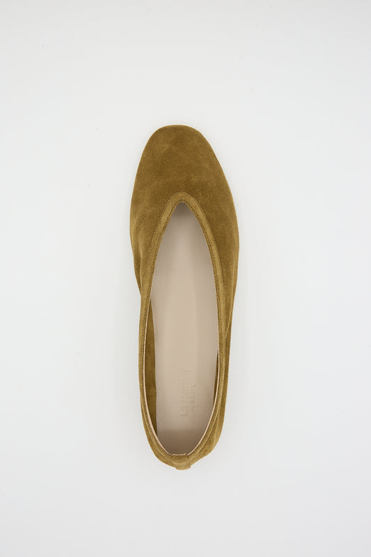A single taupe suede Luna slipper by Le Monde Beryl displayed against a white background. Overhead view.