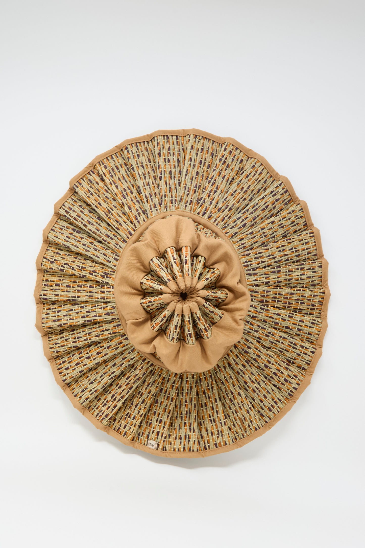The Island Capri Maxi Hat in Dawn by Lorna Murray is a round sun hat made from natural grass fibers, featuring a pleated brim and gathered center for style and UPF 50+ protection. Shown against a plain white background.