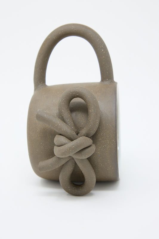 Lost Quarry's Ceramic padlock sculpture with a stylized rope knot design and a glazed interior on a white background.