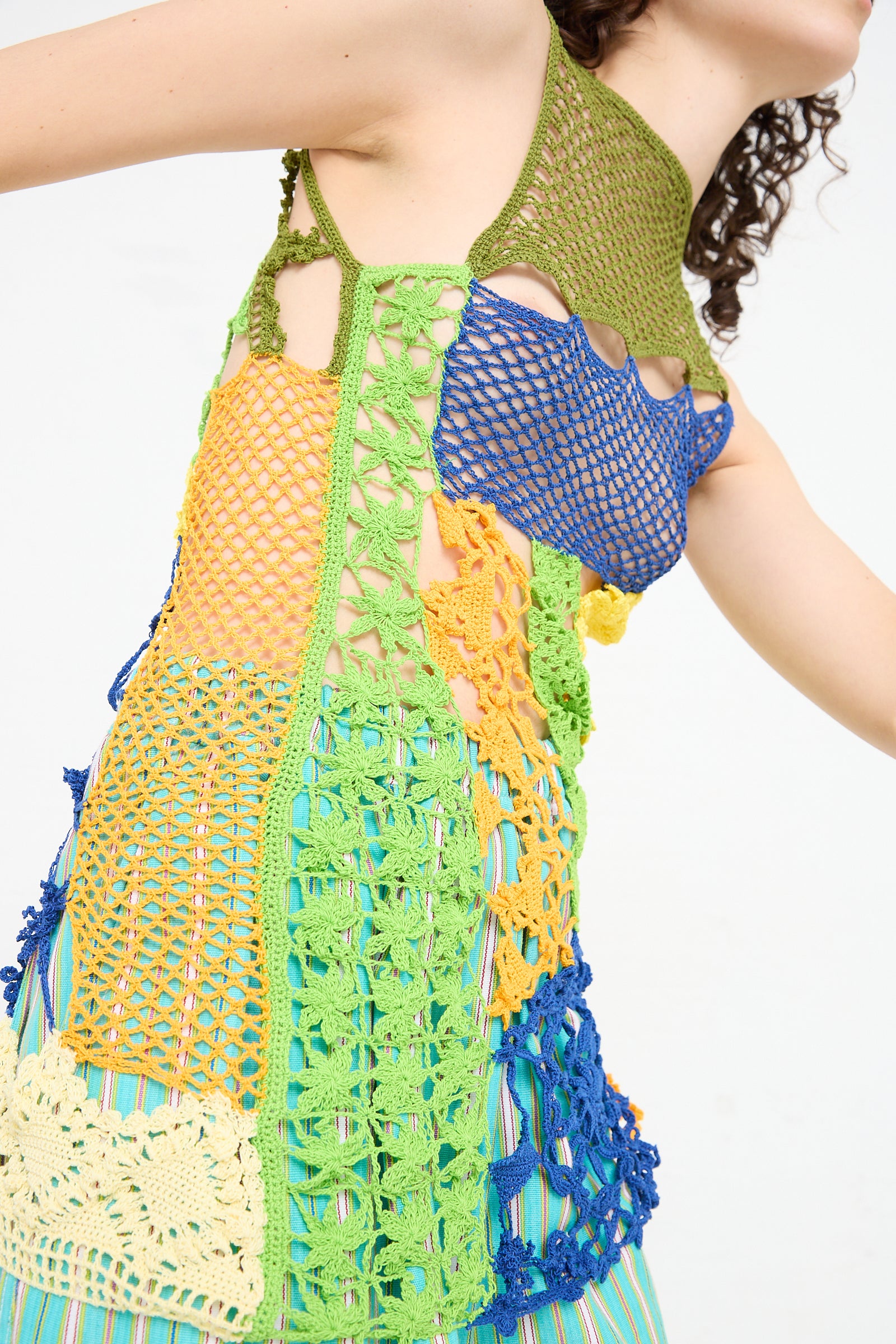 A woman wearing a Labor De Retazos Crochet Mini Dress in Multi Noise by Luna Del Pinal.