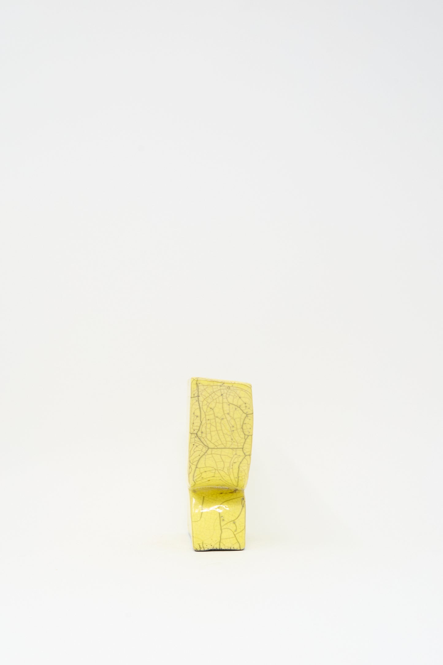 The MONDAYS Raku Semicircle Vessel in Yellow is a handmade, rectangular vase with visible crackle patterns, displayed upright against a plain white background.