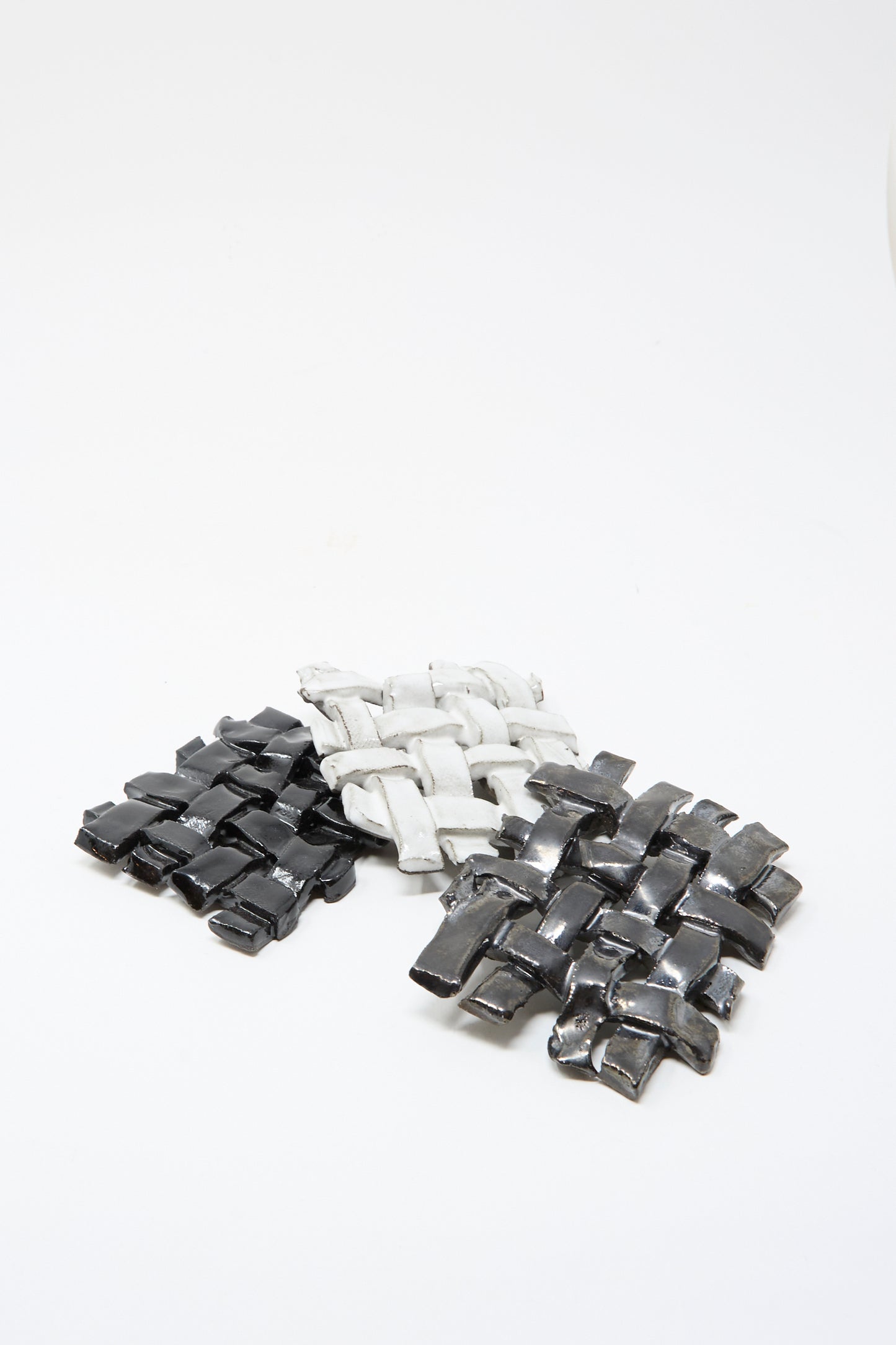 Three MONDAYS Woven Dishes in Black—featuring black glaze with gray and white tones—are arranged on a white background. Each artisanal piece is made in Brooklyn.