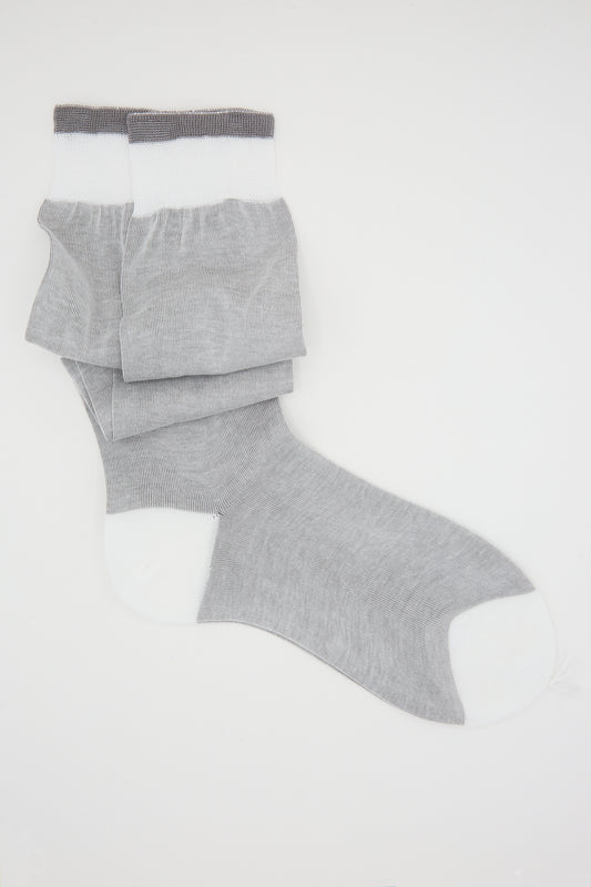 Pair of grey, handcrafted Maria La Rosa Cotton Long Socks with white toes and heels on a white background.