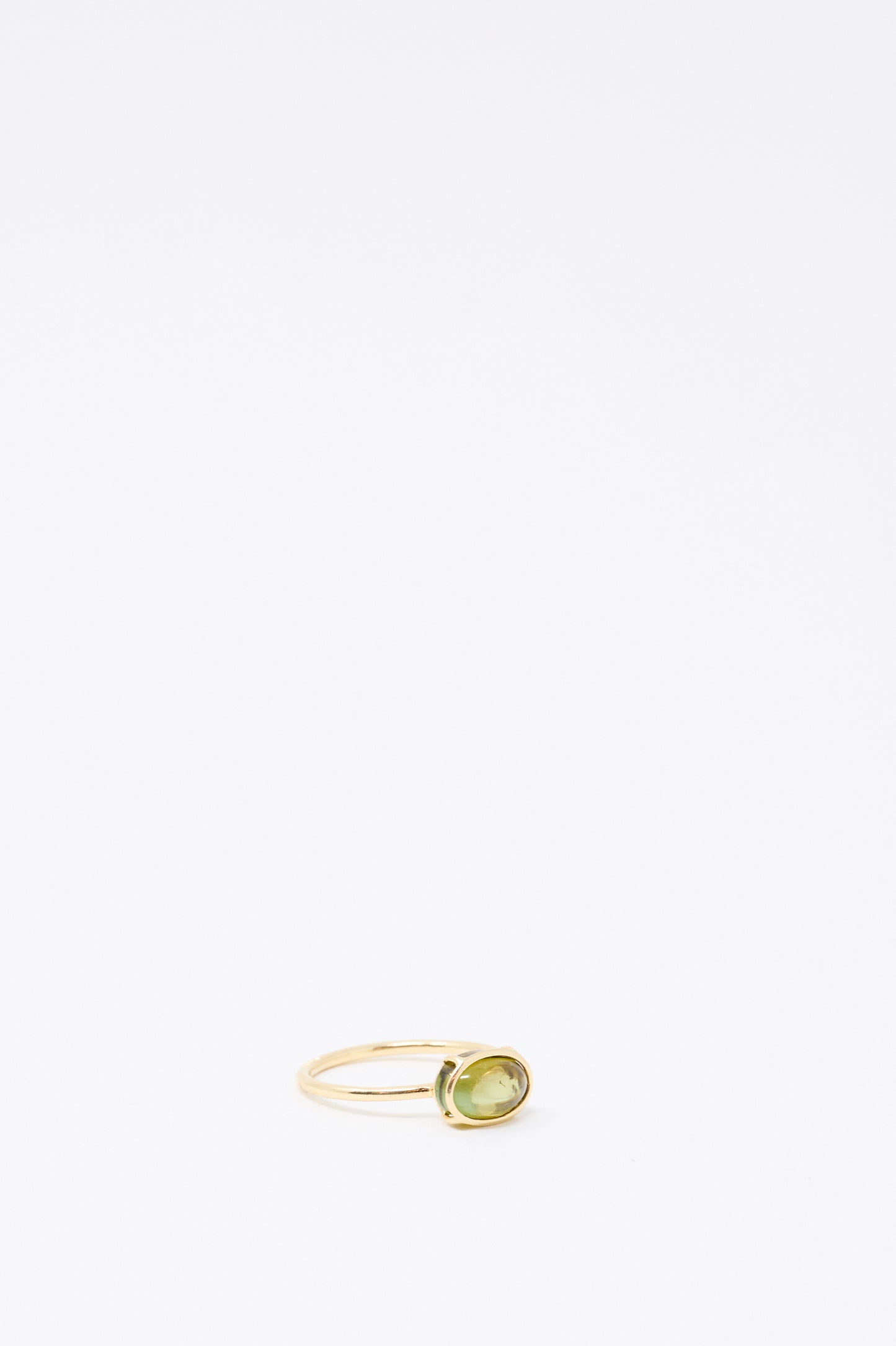 The 14K Floating Ring in Petite Green Tourmaline by Mary MacGill is displayed on a plain white background.