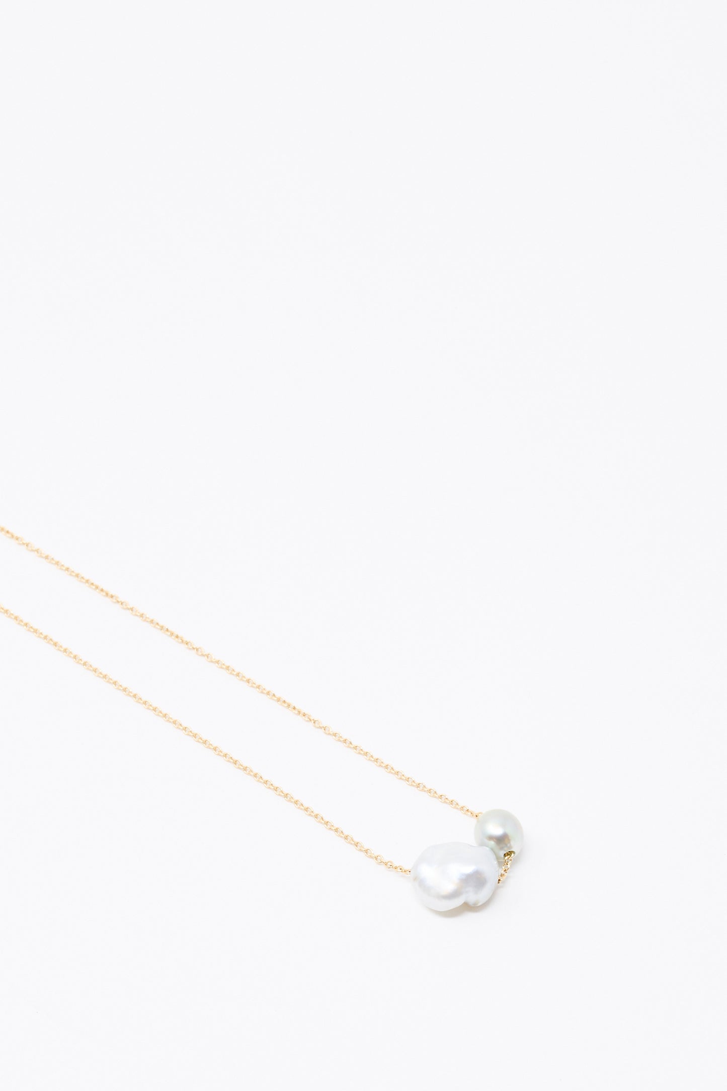 The Mary MacGill 14K Mermaids Purse Necklace features Keshi and Tahitian pearls on a delicate gold chain, shown against a plain white background.