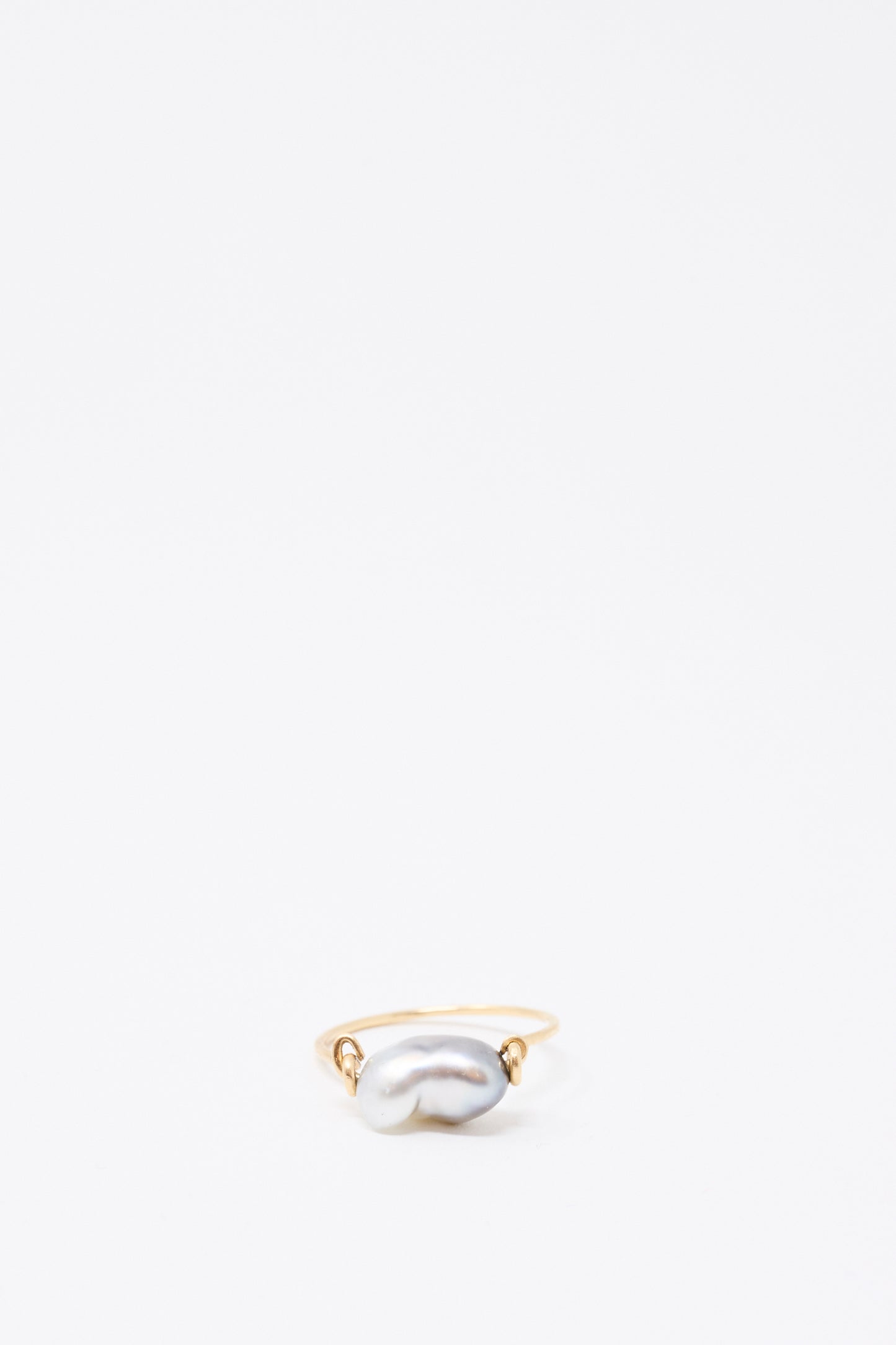 The Mary MacGill 14K Ring in Keshi Pearl showcases a handmade gold band with an irregular Keshi Pearl centerpiece, set against a plain white background.
