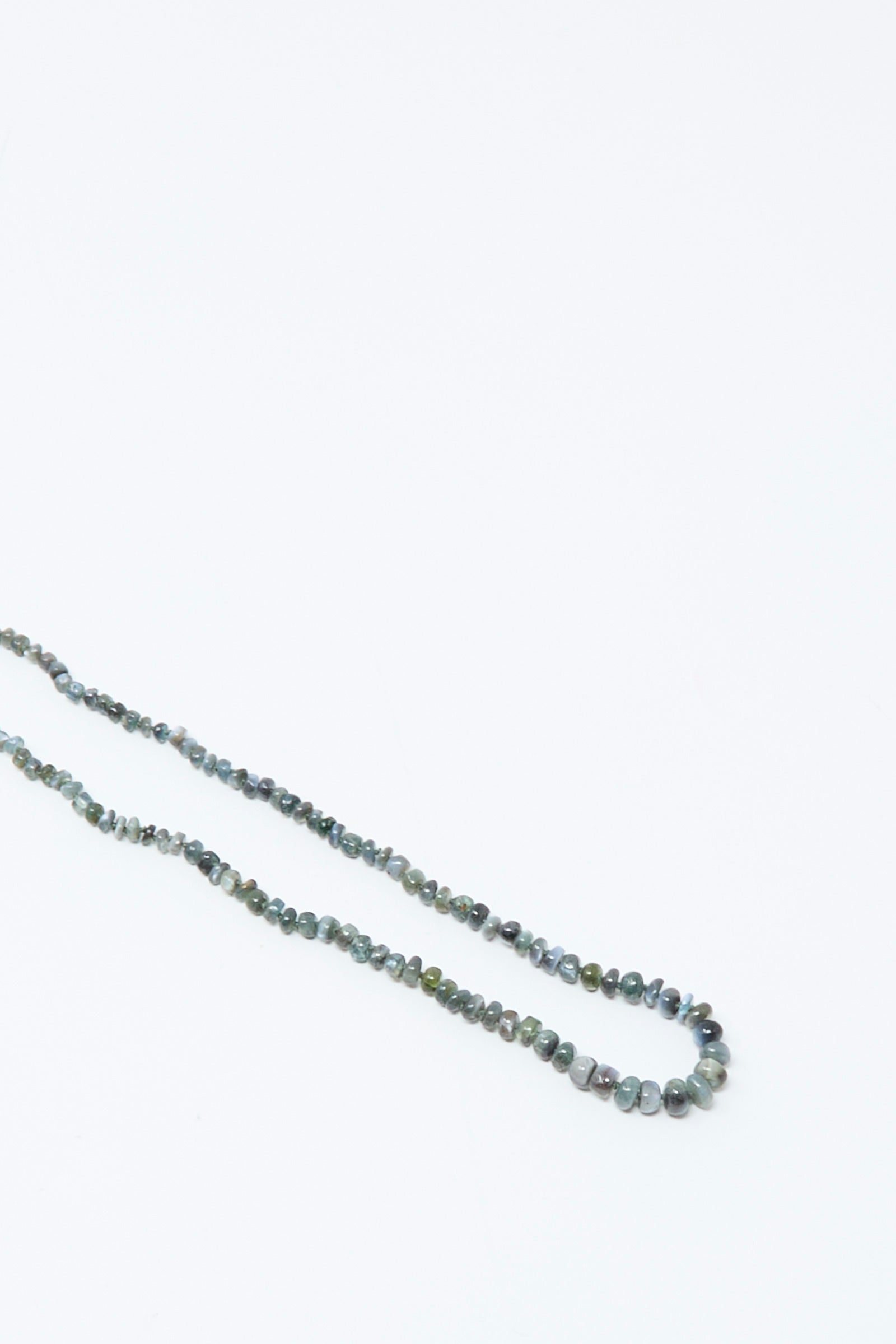 The Mary MacGill 14K Stone Layering Necklace in Cat's Eye 18" features small, round, multicolored stones arranged simply on a white background—ideal as a delicate layering necklace.