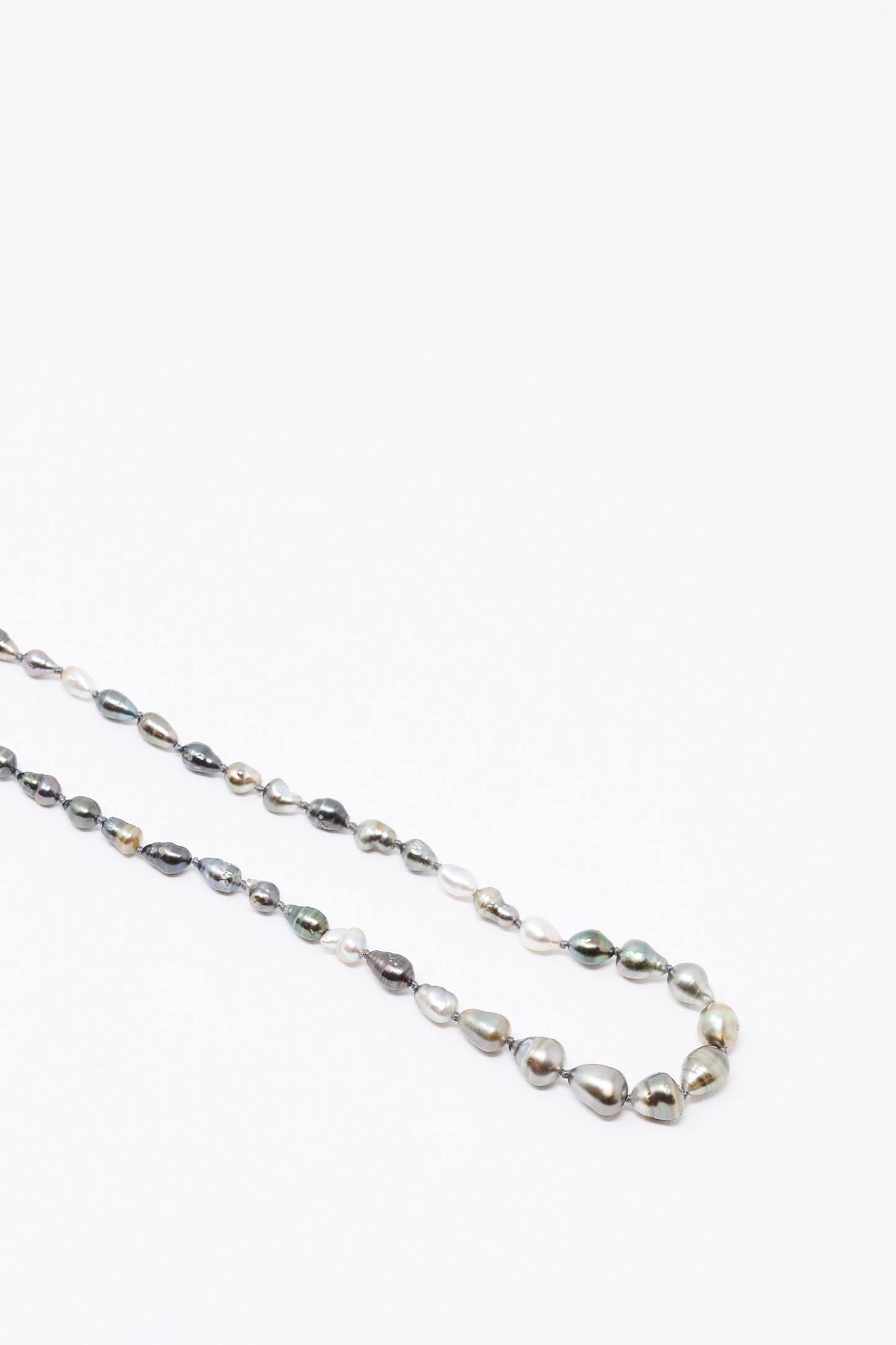 The Mary MacGill 14K Stone Layering Necklace in Keshi Pearl features a loop of irregular, multicolored pearls on a white background—ideal for layering or pairing with 14k gold accents.