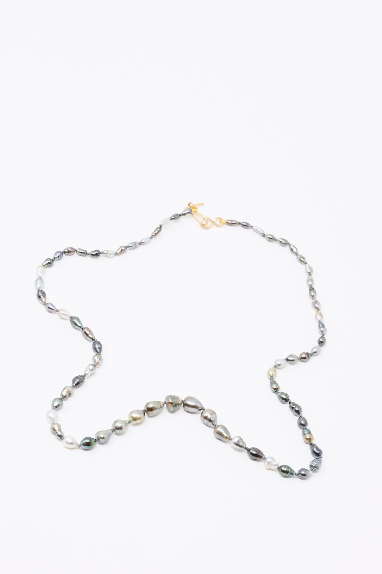 The Mary MacGill 14K Stone Layering Necklace in Keshi Pearl features irregular, multicolored pearls and a 14k gold clasp, arranged in a star shape on a white background.