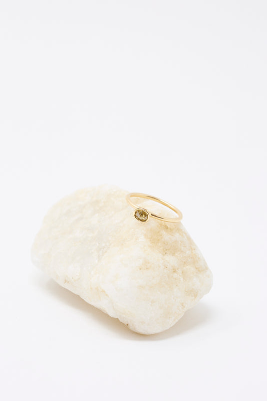 The Mary MacGill 14K Floating Ring features a cognac rose cut mineral diamond, displayed on a light-colored rock against a white background.