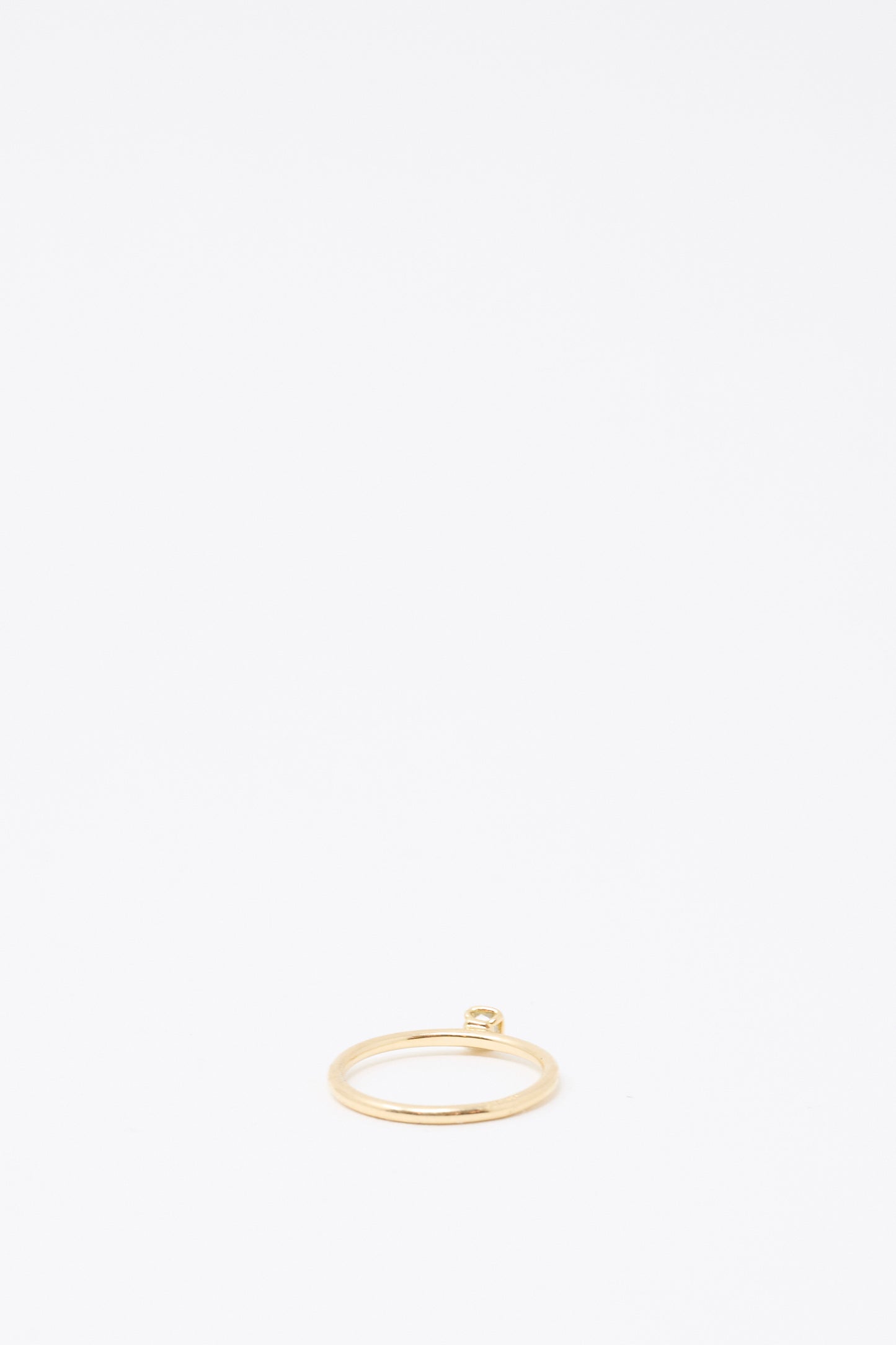 The Mary MacGill 14K Floating Ring features a petite, light green rose-cut mineral diamond, set atop a thin gold band and displayed against a plain white background.