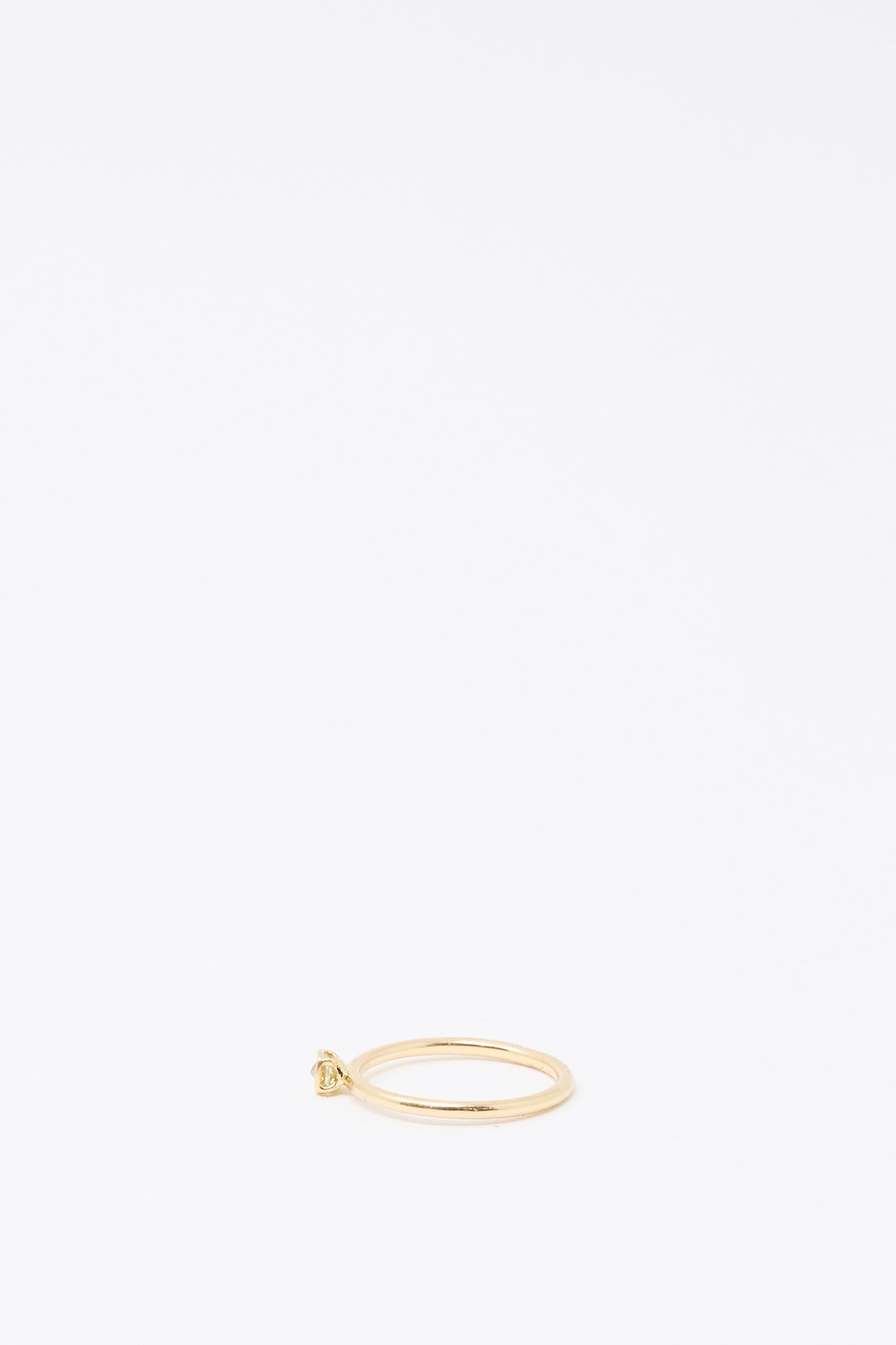 The Mary MacGill 14K Floating Ring in Petite Light Green Rose Cut Mineral Diamond is placed near the bottom center of a white background.