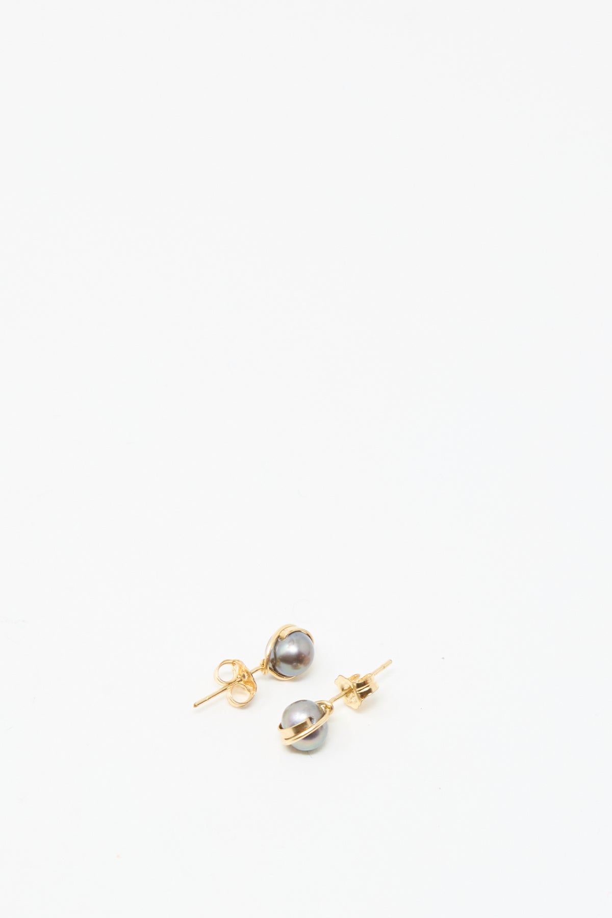 The Mary MacGill Baroque Pearl Studs in Charcoal feature round gray pearls on gold-filled posts, displayed against a plain white background.