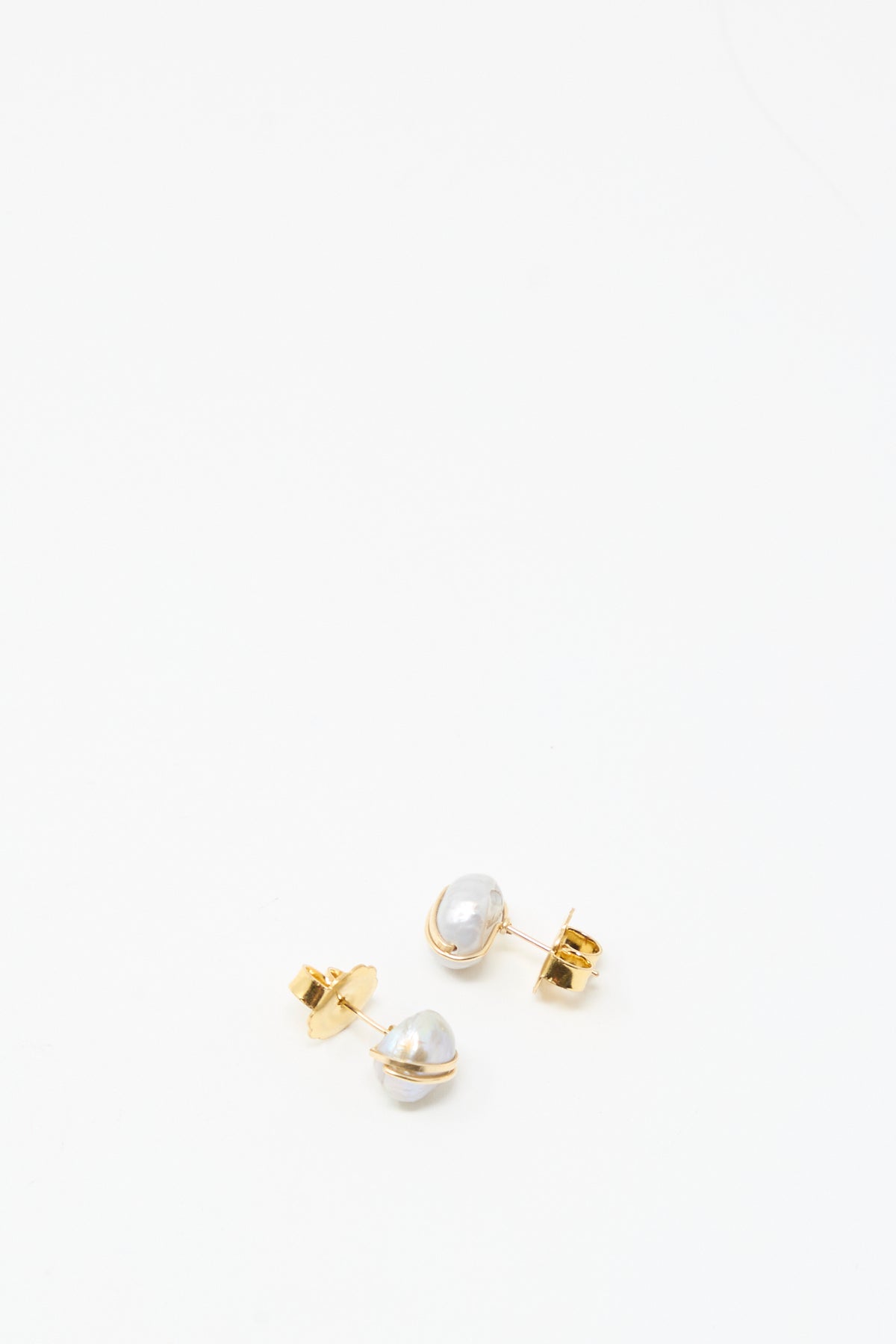 The Grande Baroque Pearl Studs in Silver by Mary MacGill feature silver baroque pearls wrapped in gold-filled wire, shown against a plain white background.