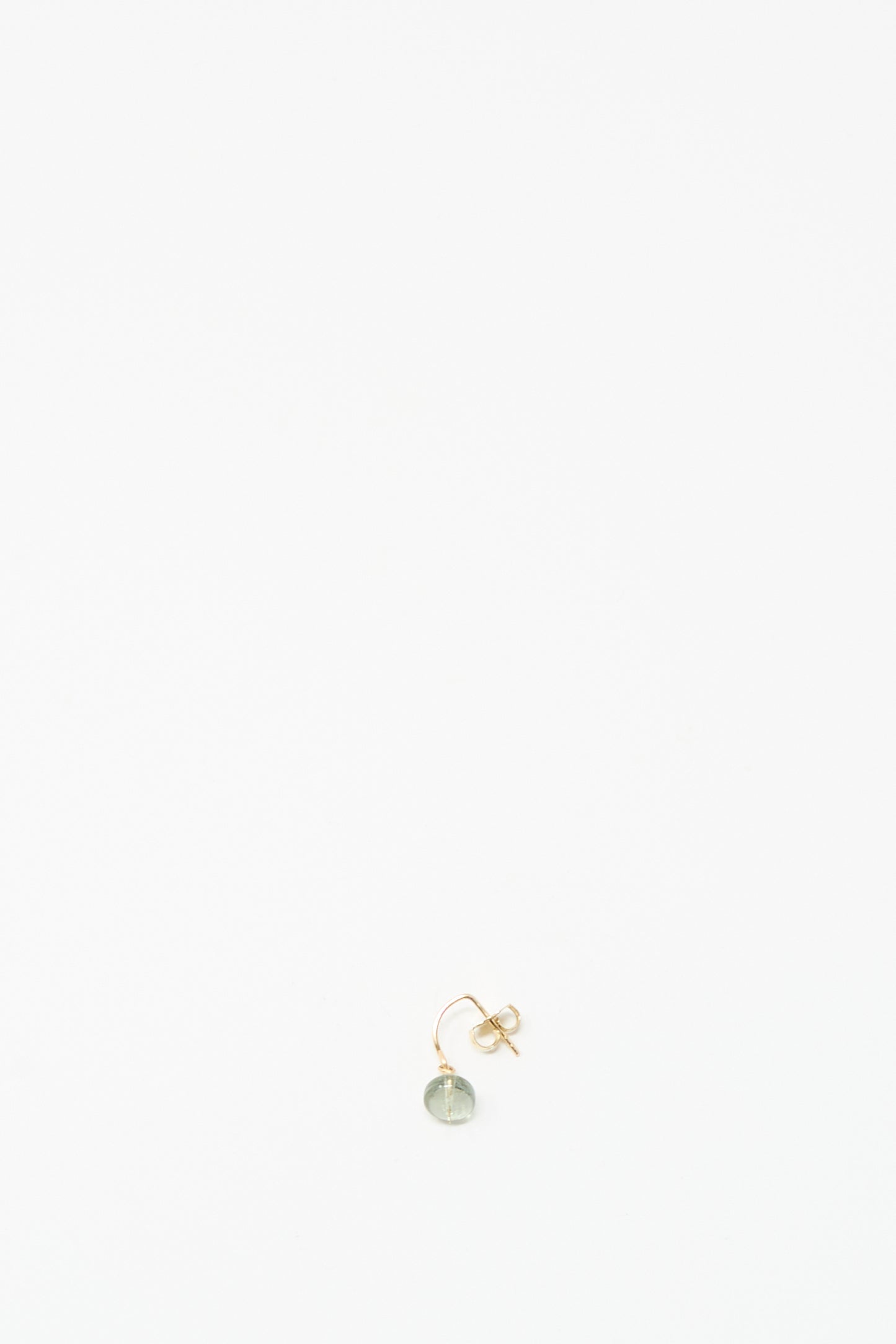 The Mary MacGill 14K Crescent Charm Earring features a small round pale tourmaline stone and is shown on a white background.