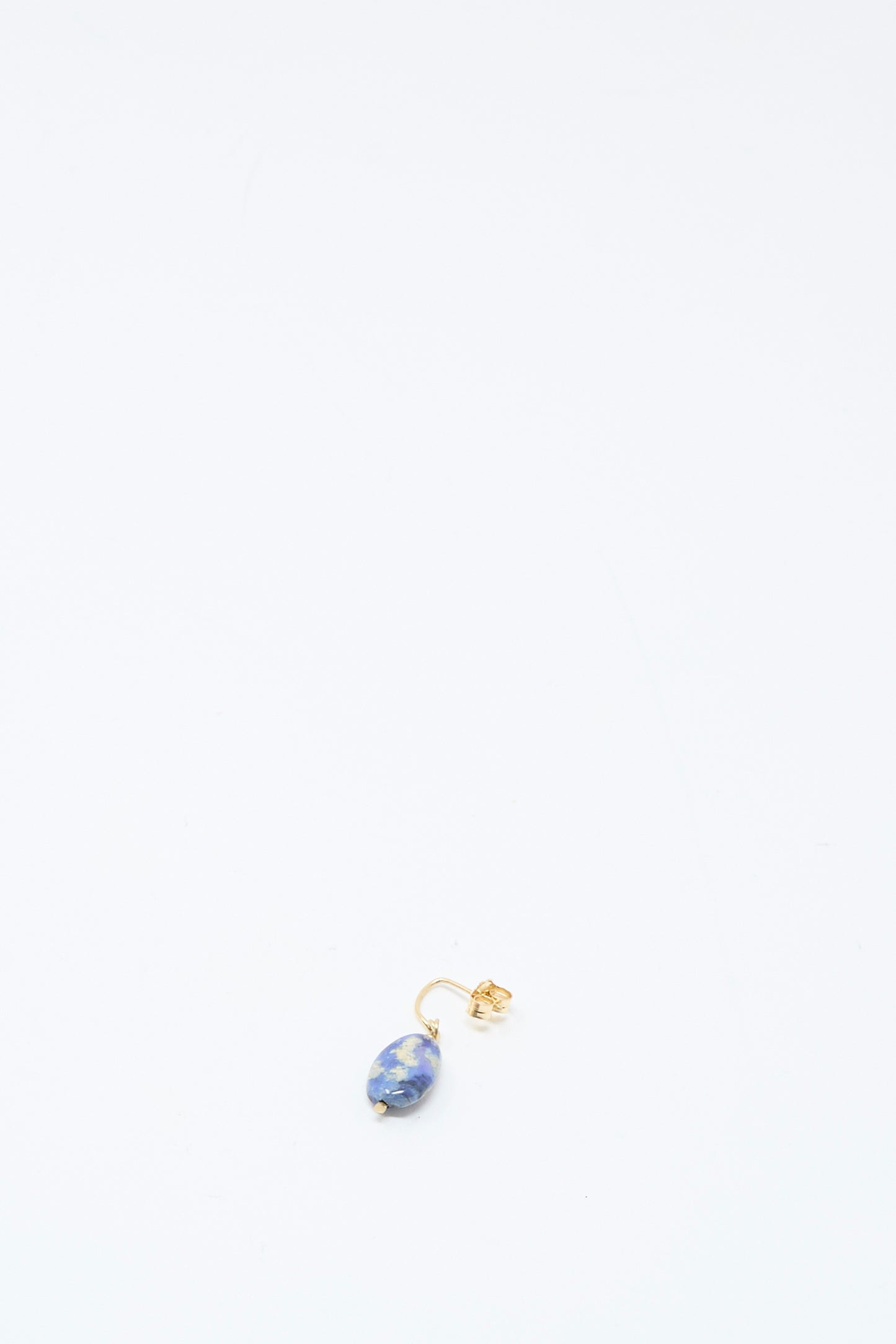 The Mary MacGill 14K Crescent Charm Single Earring in Dumortierite Quartz is shown near the bottom center against a white background.