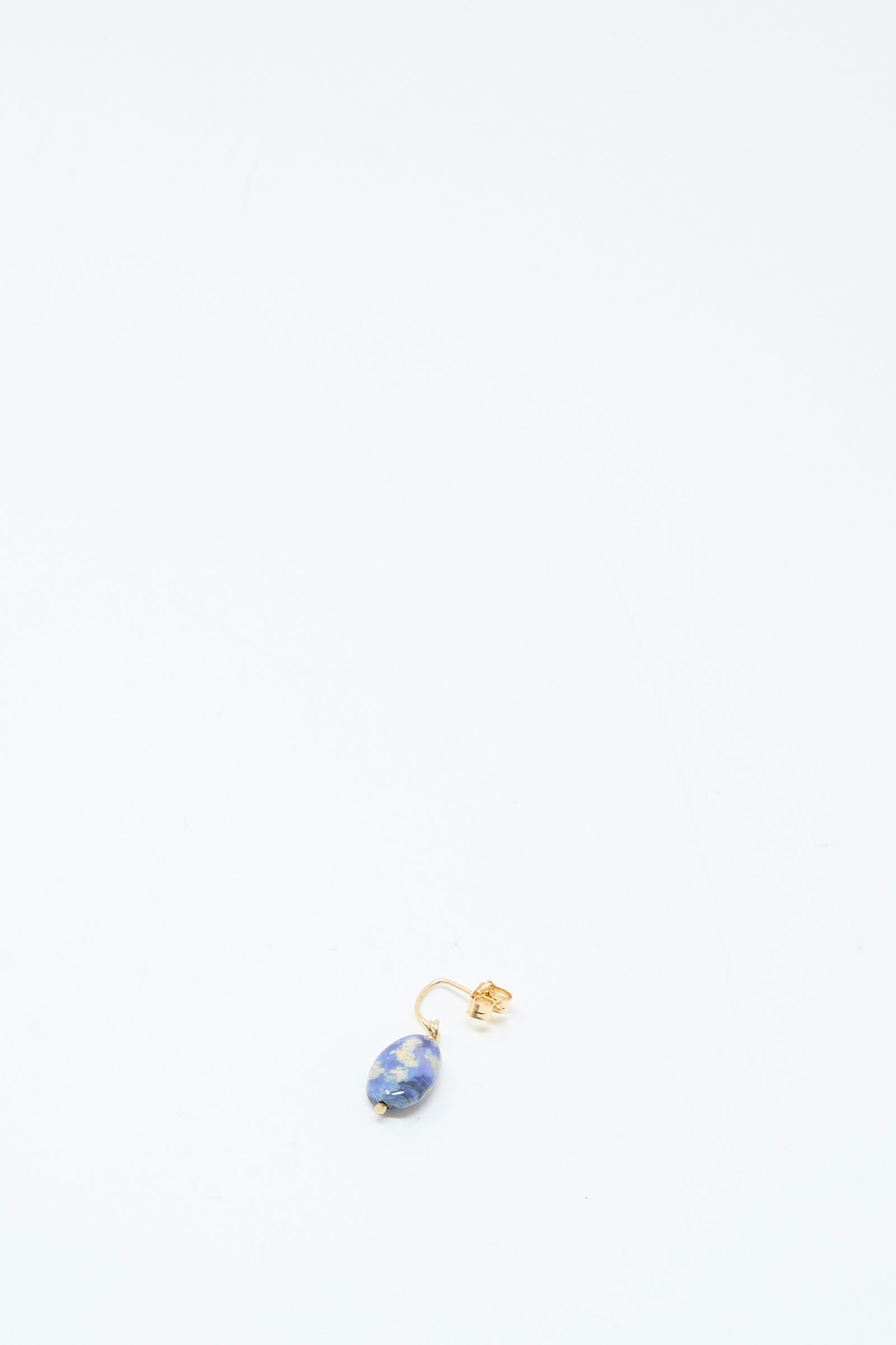 The Mary MacGill 14K Crescent Charm Single Earring in Dumortierite Quartz is shown near the bottom center against a white background.