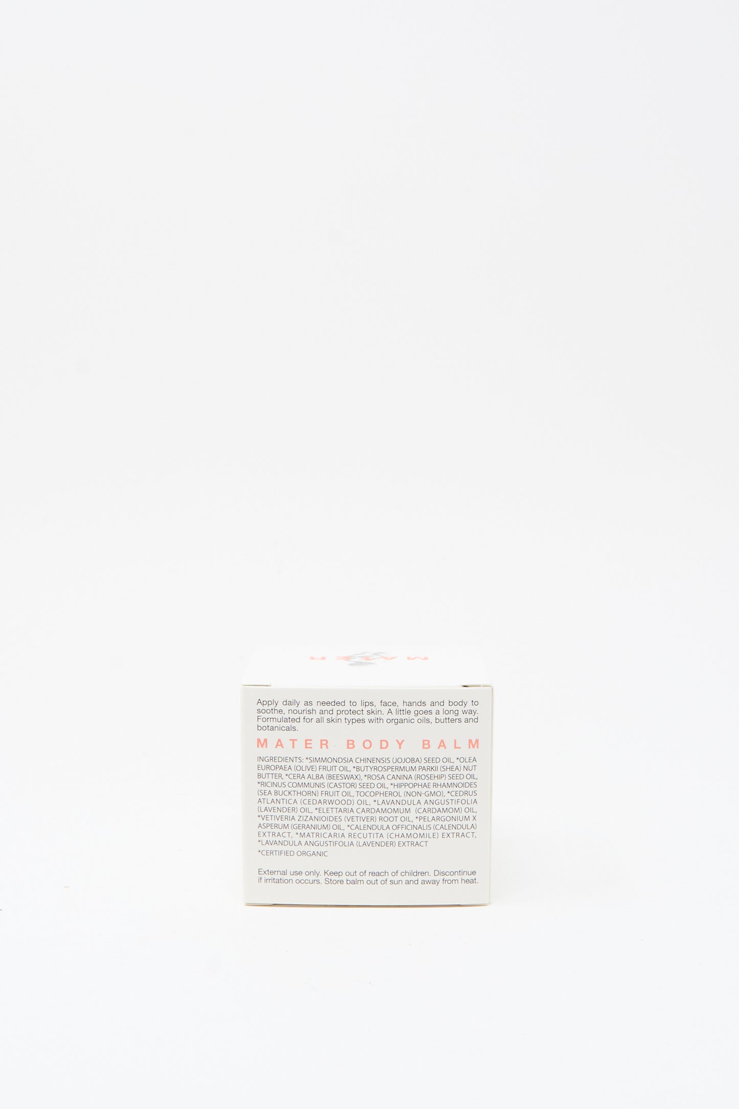 A small white box labeled "Mater Soap Cardamom and Cedarwood Body Balm 3oz" with usage instructions and details on the front, featuring a cardamom and cedarwood balm formula, set against a plain white background.