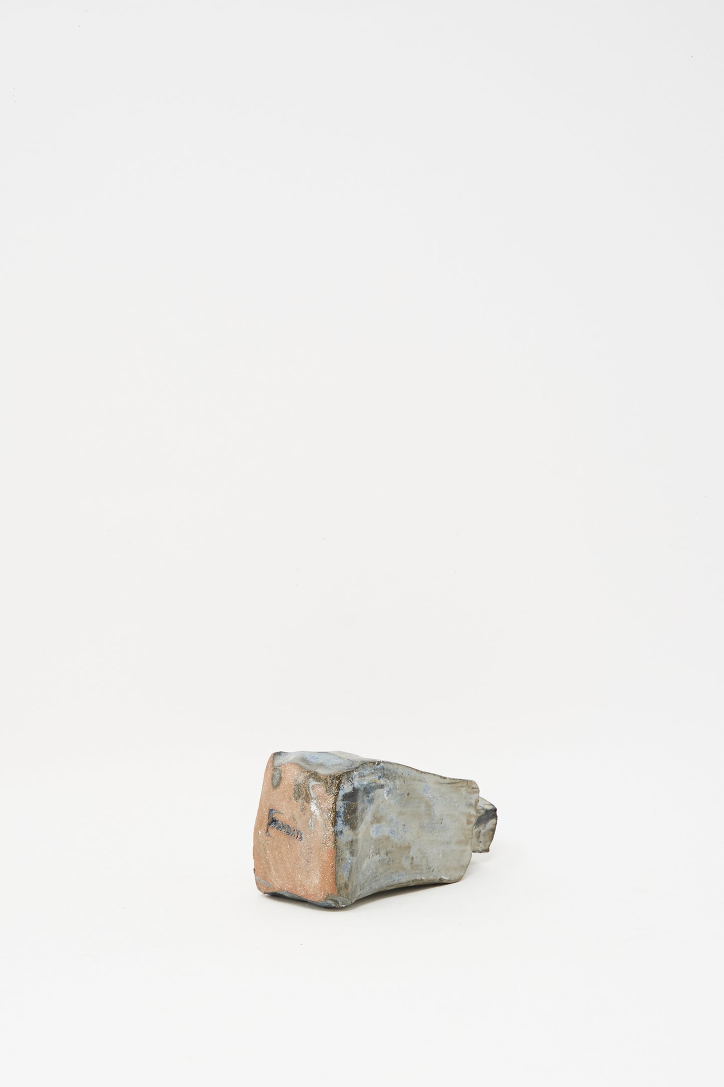 The Carved Bud Vase II by MONDAYS is a small, uniquely shaped clay vase with a textured finish, set against a light background—reminiscent of artisanal pieces found in Brooklyn.