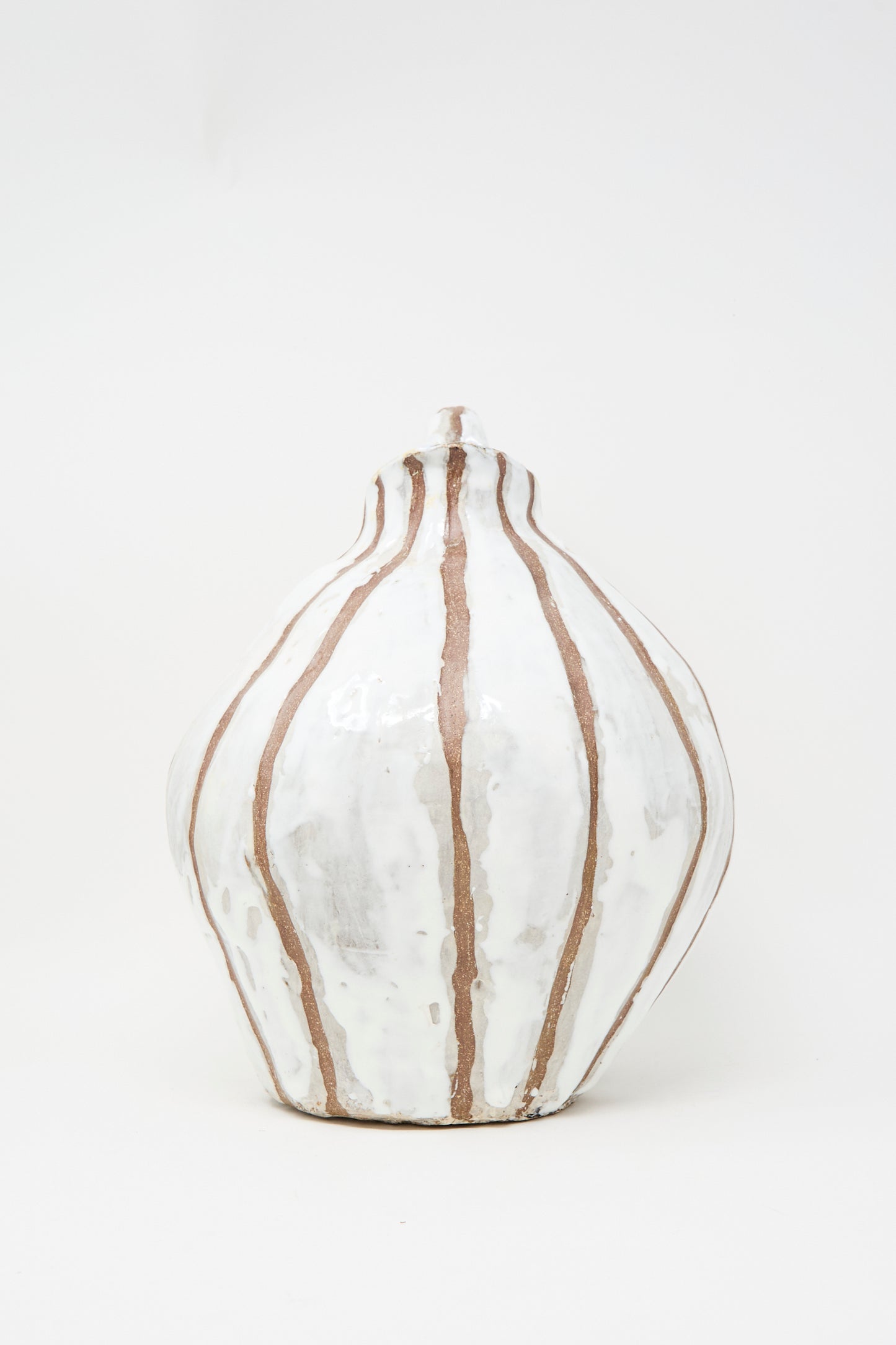 The MONDAYS Coil-built Glazed Stoneware Striped Pitcher Vase features vertical brown stripes on white ceramic in a rounded shape. Set against a plain white background. Available for in-store pickup.