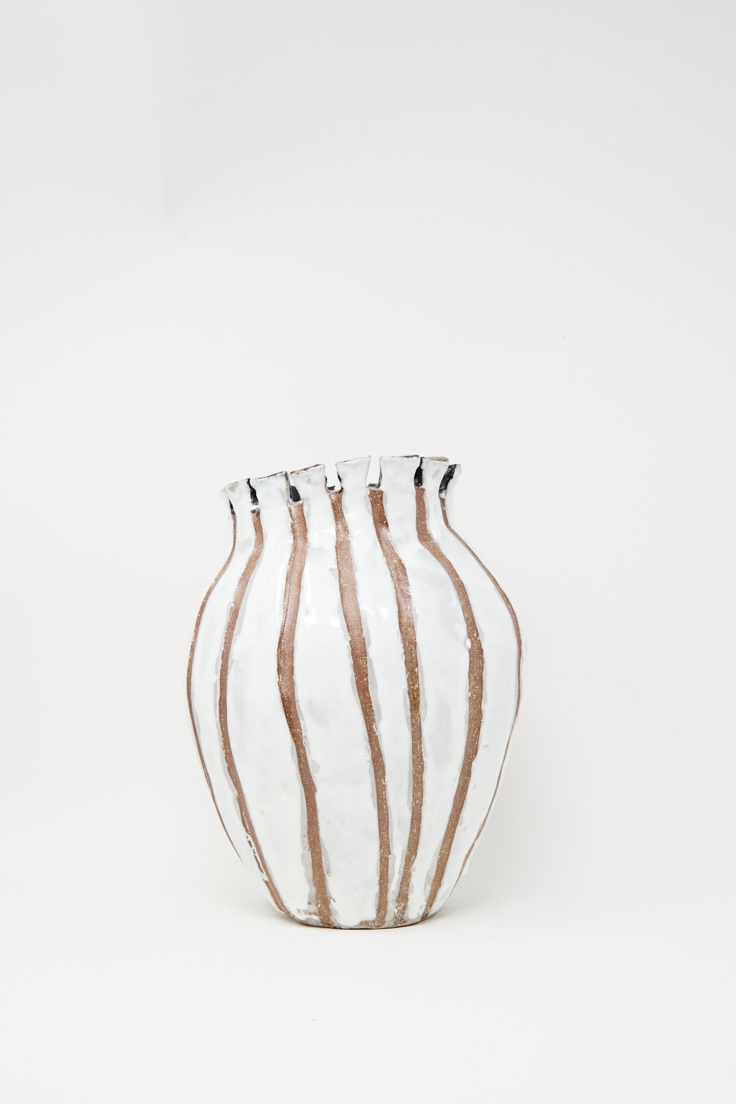 The MONDAYS Coil-built Glazed Stoneware Striped Vase has a wavy rim and vertical brown-and-white stripes, displayed against a plain white background.