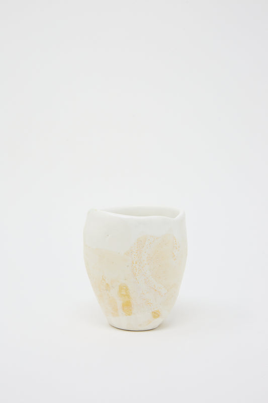 A MONDAYS white hand-built Porcelain Tumbler in Beige and White with a textured glaze on a white background.