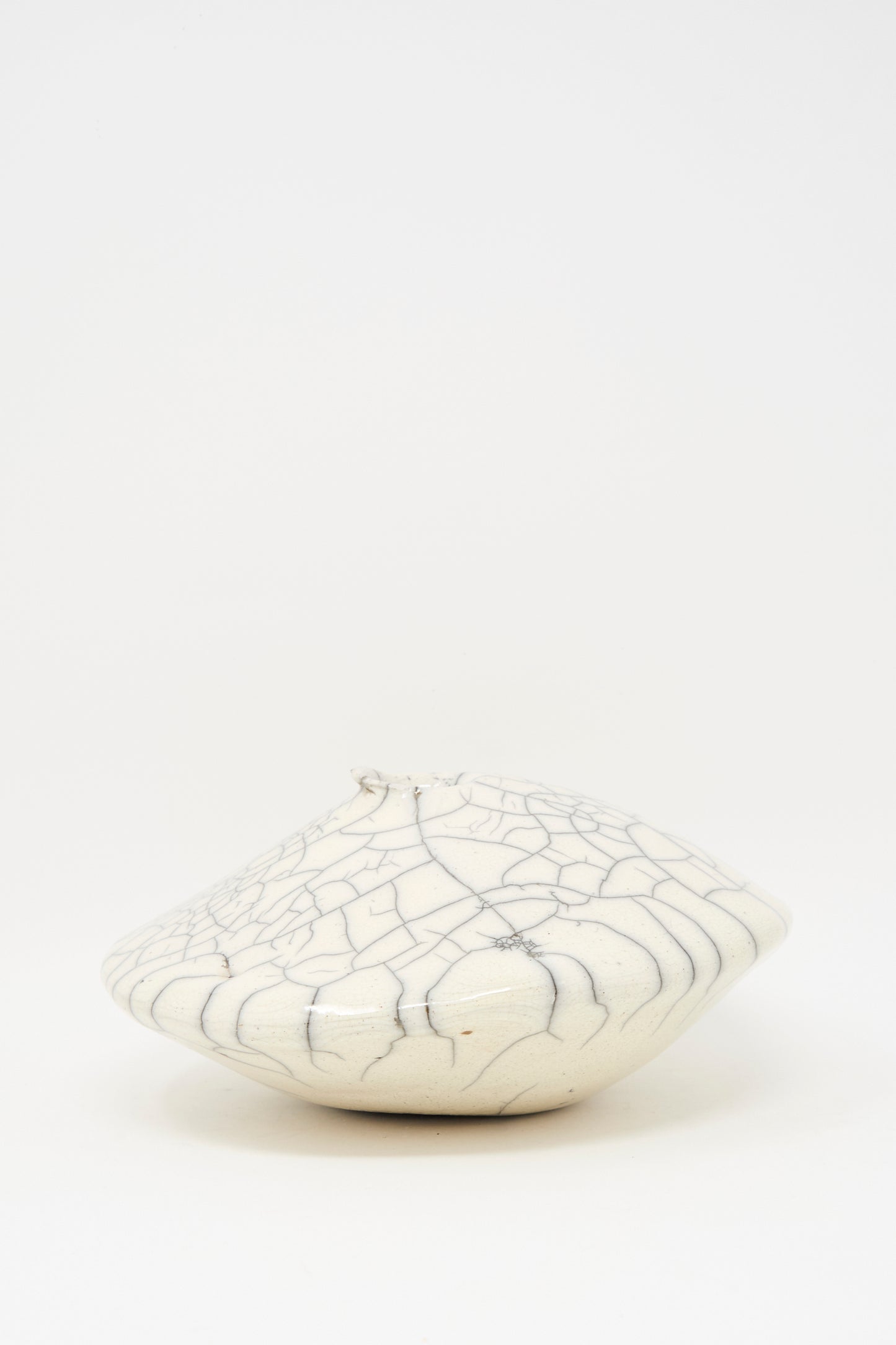 The MONDAYS Raku Ikebana Vase Large is a white, round ceramic vase with a narrow opening and crackle glaze, pictured against a plain white background.