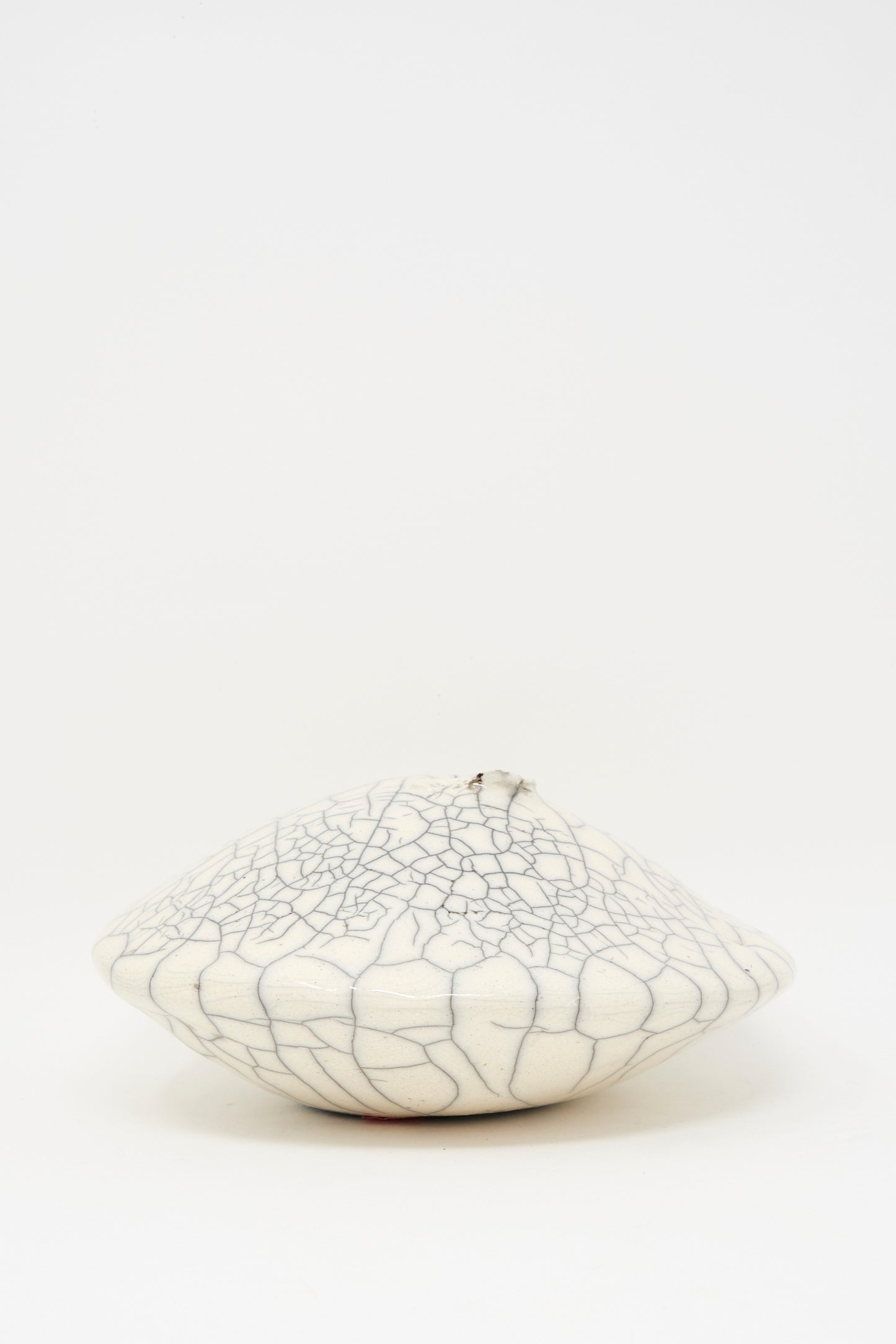 The MONDAYS Raku Ikebana Vase Large features a round, white, flattened design with a unique crackle glaze, beautifully displayed against a plain white background.