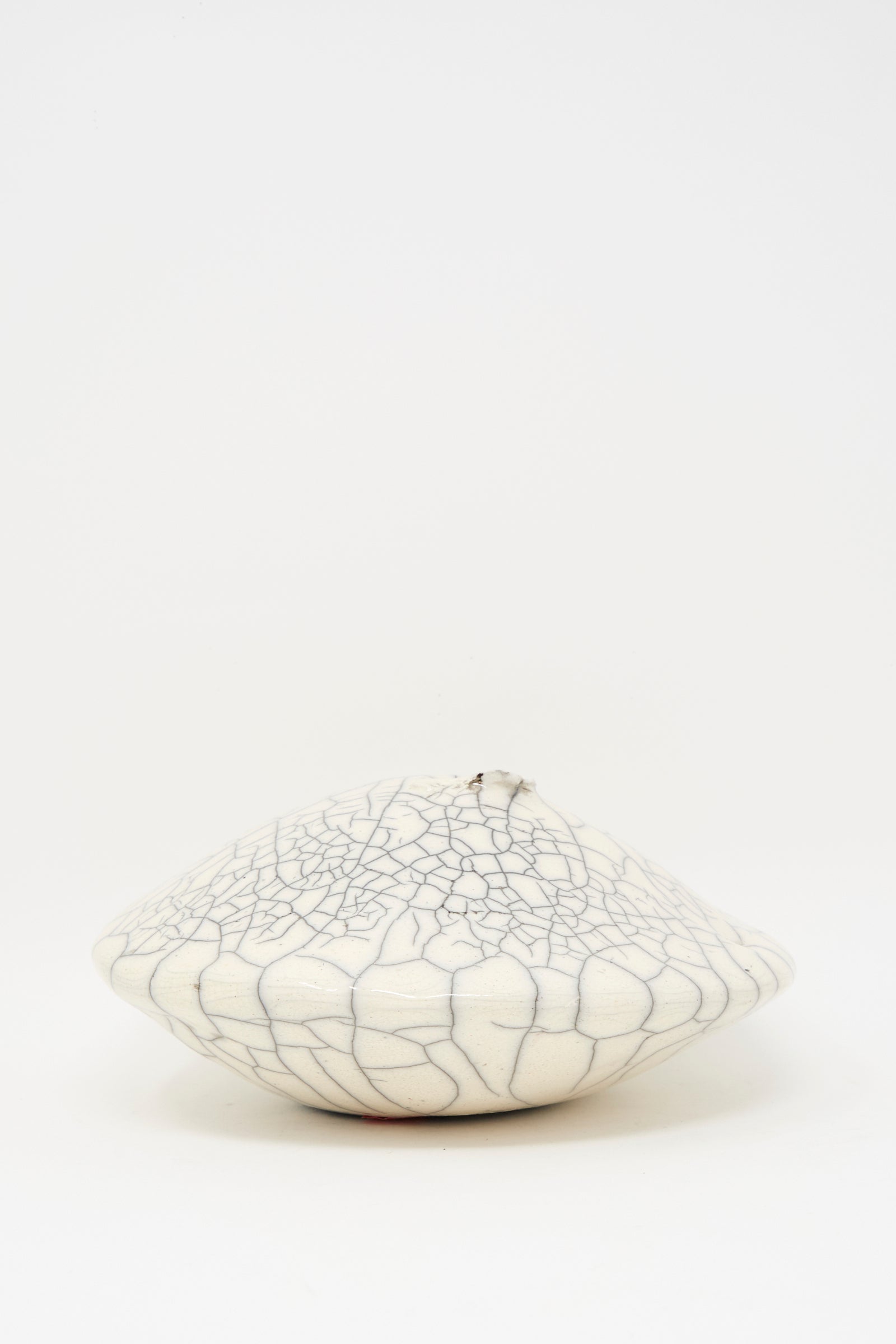 The MONDAYS Raku Ikebana Vase Large features a round, white, flattened design with a unique crackle glaze, beautifully displayed against a plain white background.