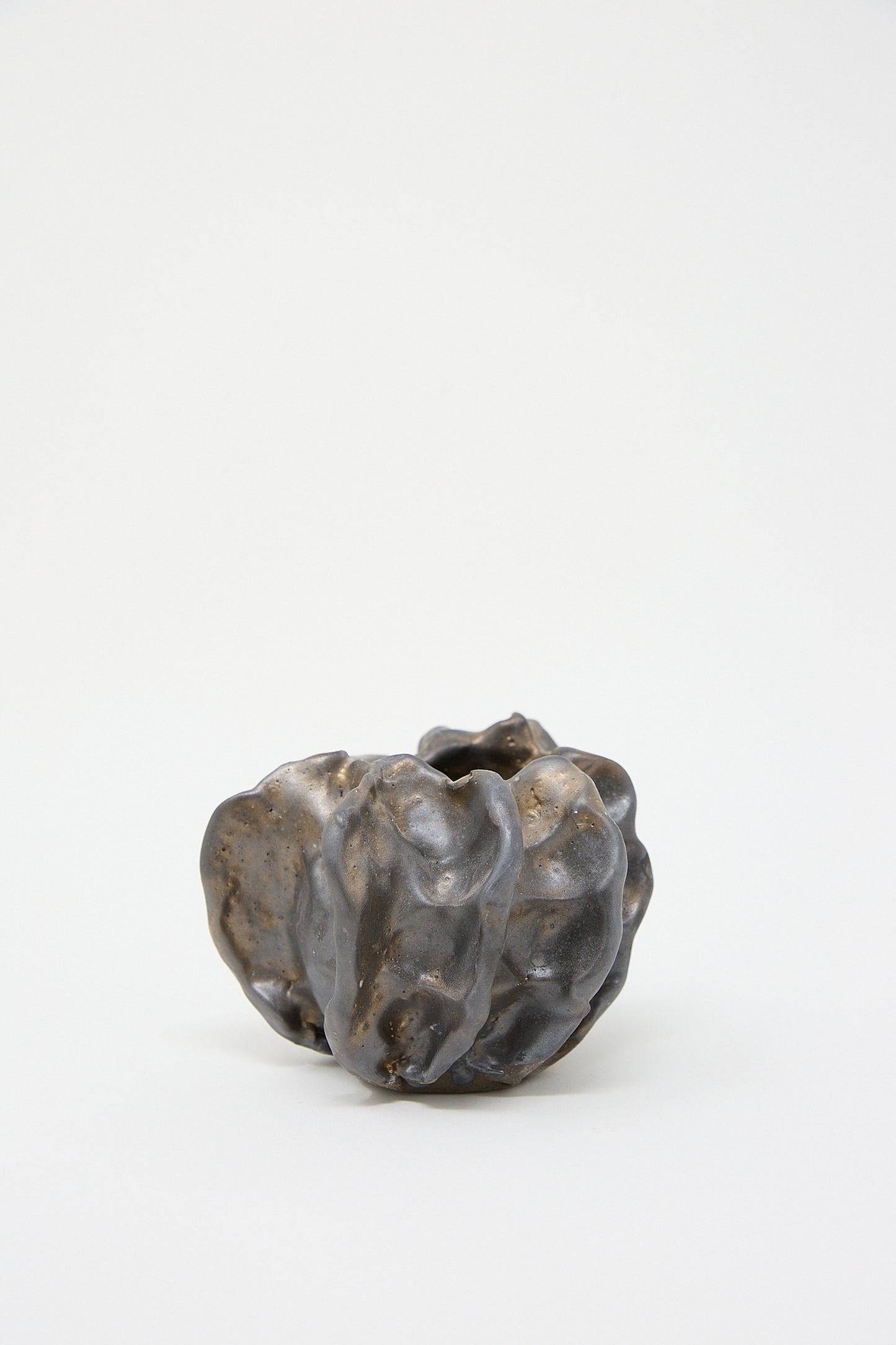 A MONDAYS Urchin Vessel in Glazed Stoneware in black and brown on a white surface.