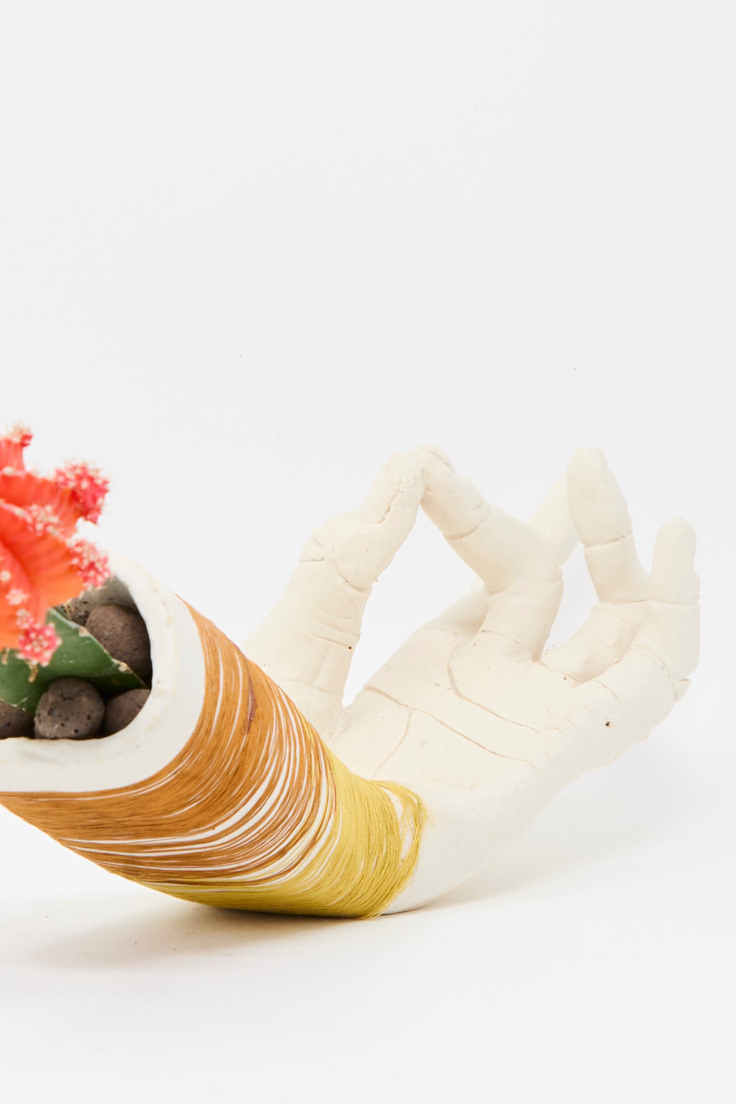 The Ceramic Hand Sculpture with Yellow and Rust Thread by Monty J, handmade in Brooklyn, is photographed against a plain white background.