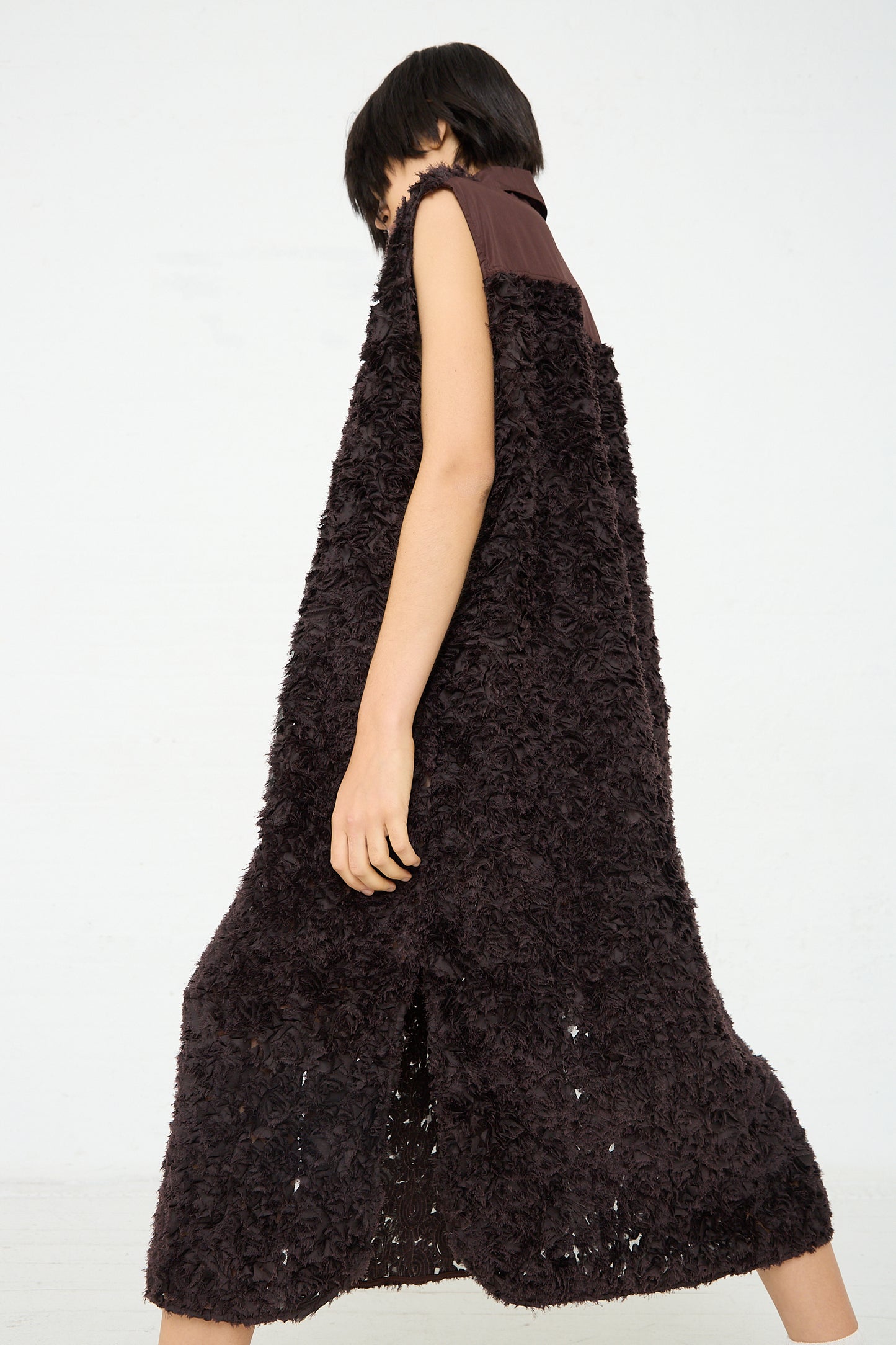 A woman wearing an Embroidered Tulle Beagle Shirt Dress in Dark Brown by Niccolò Pasqualetti. Back view.
