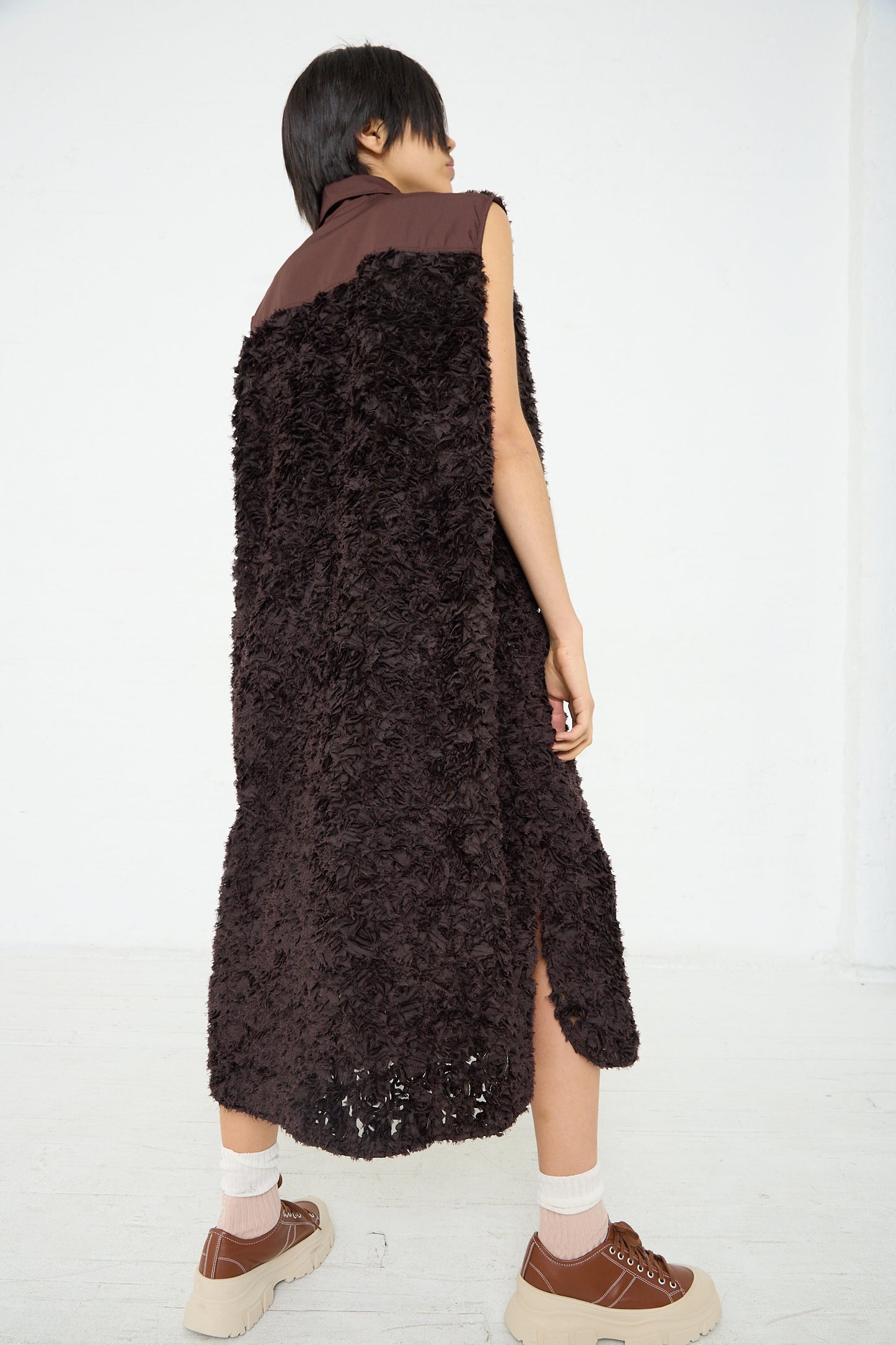 The back of a woman wearing the Niccolò Pasqualetti Embroidered Tulle Beagle Shirt Dress in Dark Brown.