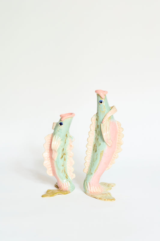 The Pearce Williams Fish Vase Small in Green stands upright against a plain white background, highlighting its handmade craftsmanship and unique ceramic fish shape.