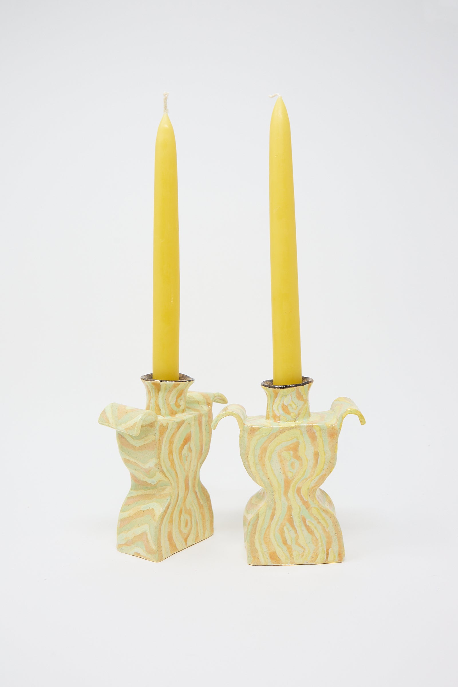 Two Pearce Williams woodgrain candlesticks pair in matching swirl-patterned handcrafted ceramic candle holders on a white background.