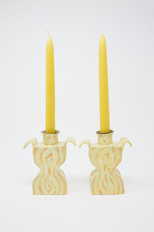 Two Woodgrain Candlesticks Pair standing in ornate, handcrafted ceramic candle holders against a white background. (Brand Name: Pearce Williams)