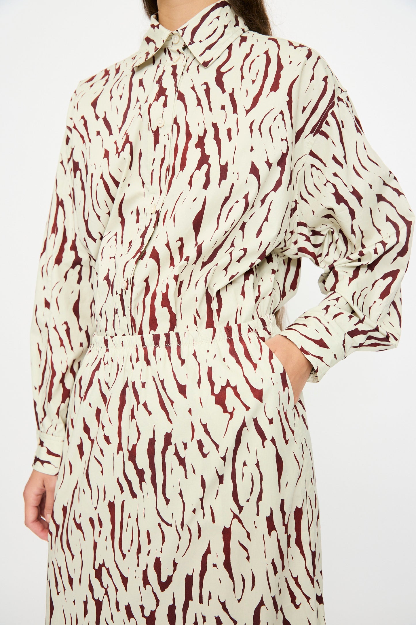 Person wearing the Rachel Comey Lastica Skirt in Cream, one hand in pocket, standing against a plain background.
