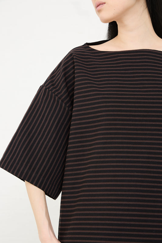 Woman wearing a Rachel Comey Ode Top in Black with a focus on the sleeve design.