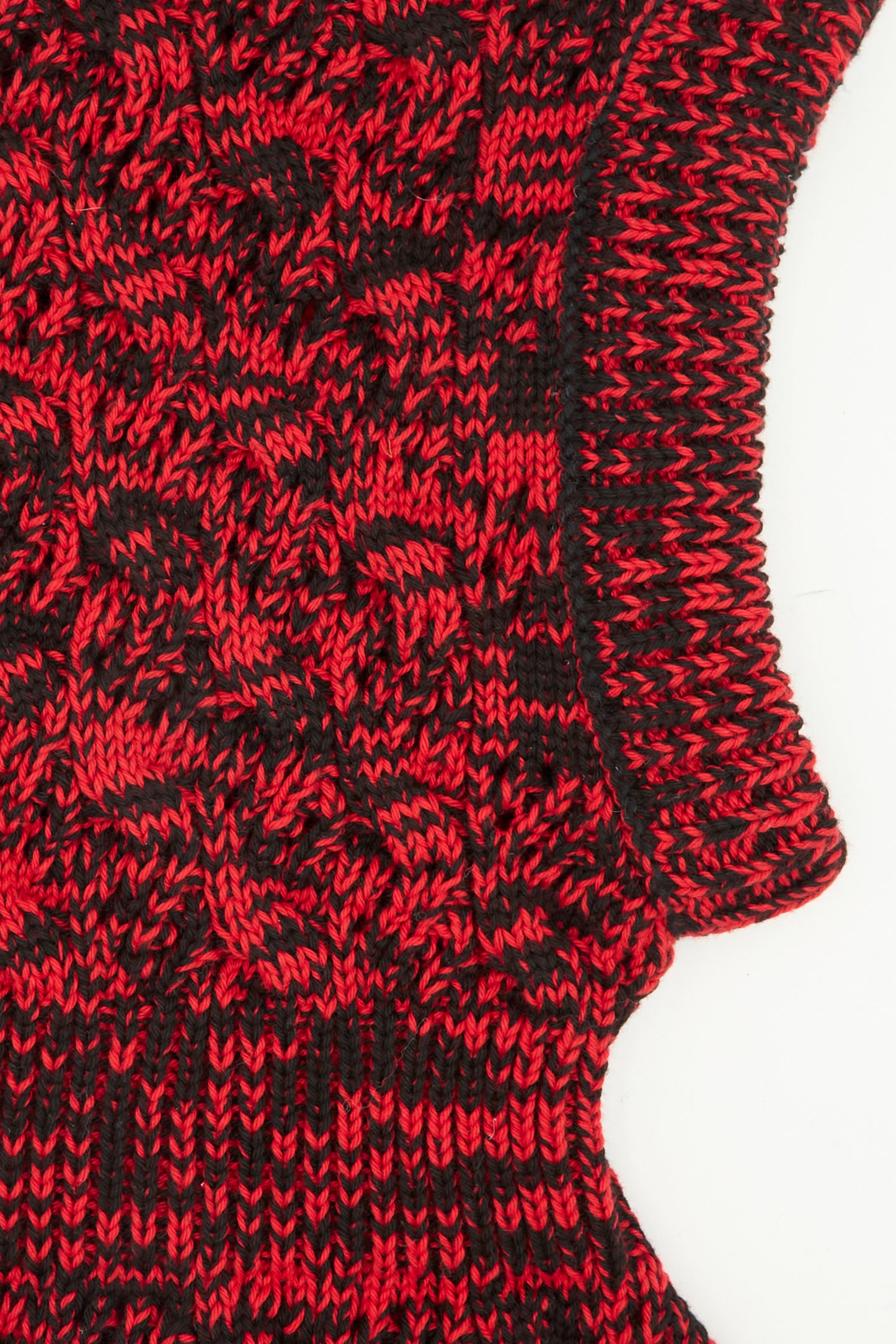 Close-up of the Zet Balaclava in Red Marle by Rachel Comey, featuring black and red marled knit, ribbed collar, and curved edge on a white background.