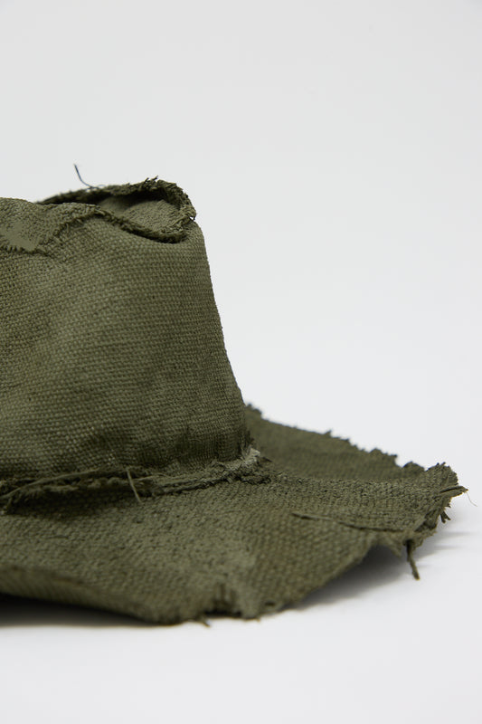 Close-up of a worn, frayed Reinhard Plank Beghe S Jute Hat in Green on a white background.
