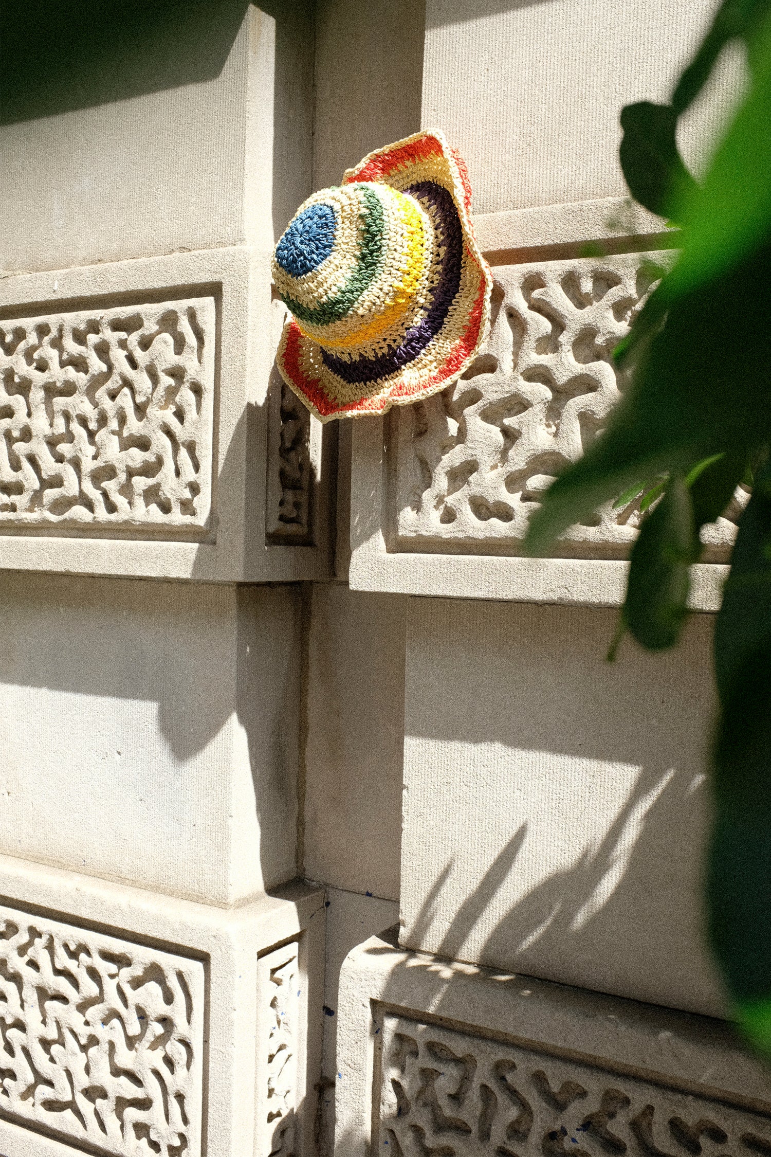 The Reinhard Plank Paper Unci Isle Hat in Stripes resting on a building. Available at Oroboro Store, NYC.