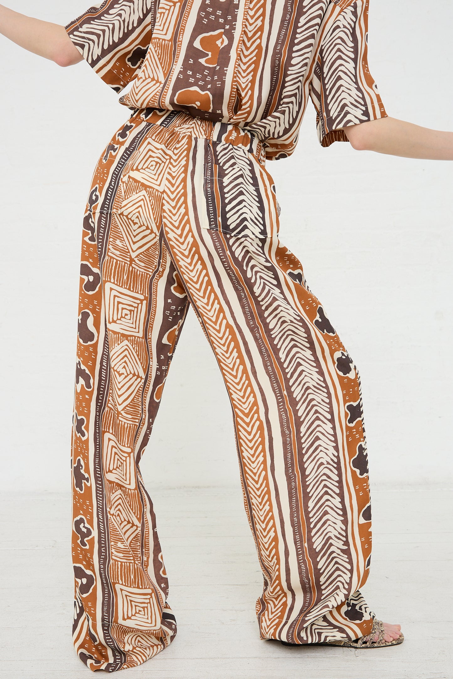 Rejina Pyo Andi Trouser in Print Brown and blouse outfit on a model against a white background.