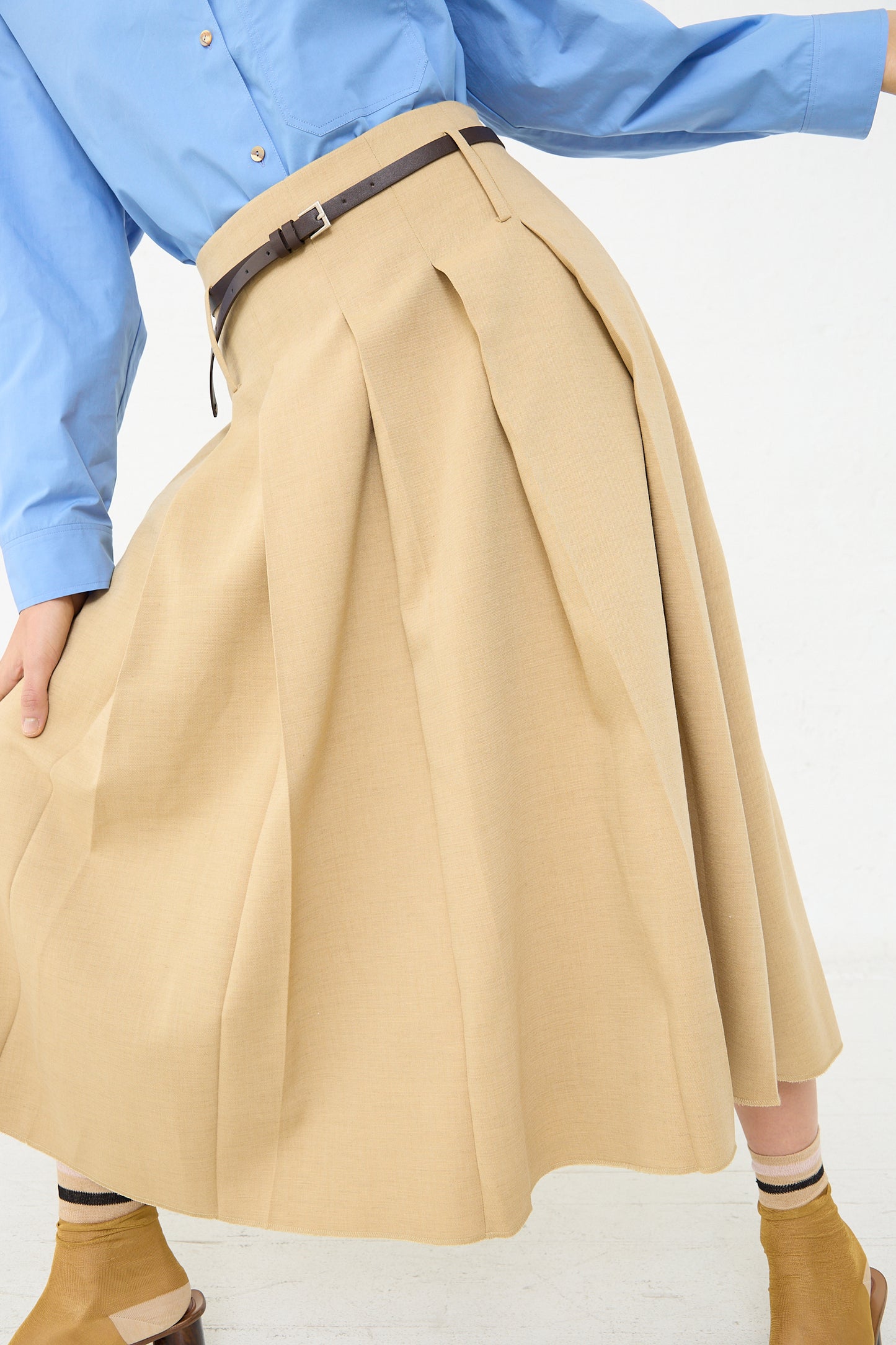 A woman wearing the Rejina Pyo Odette Skirt in Beige.