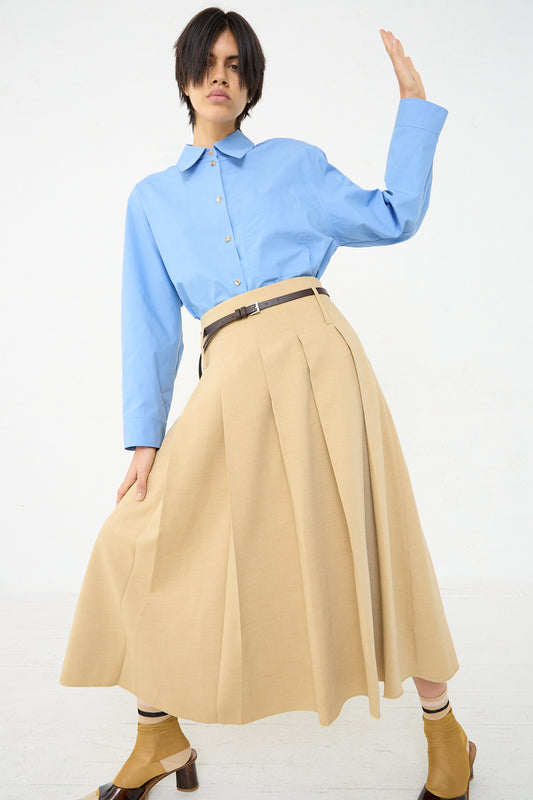 A woman in the Rejina Pyo Odette Skirt in Beige. Full length front view.