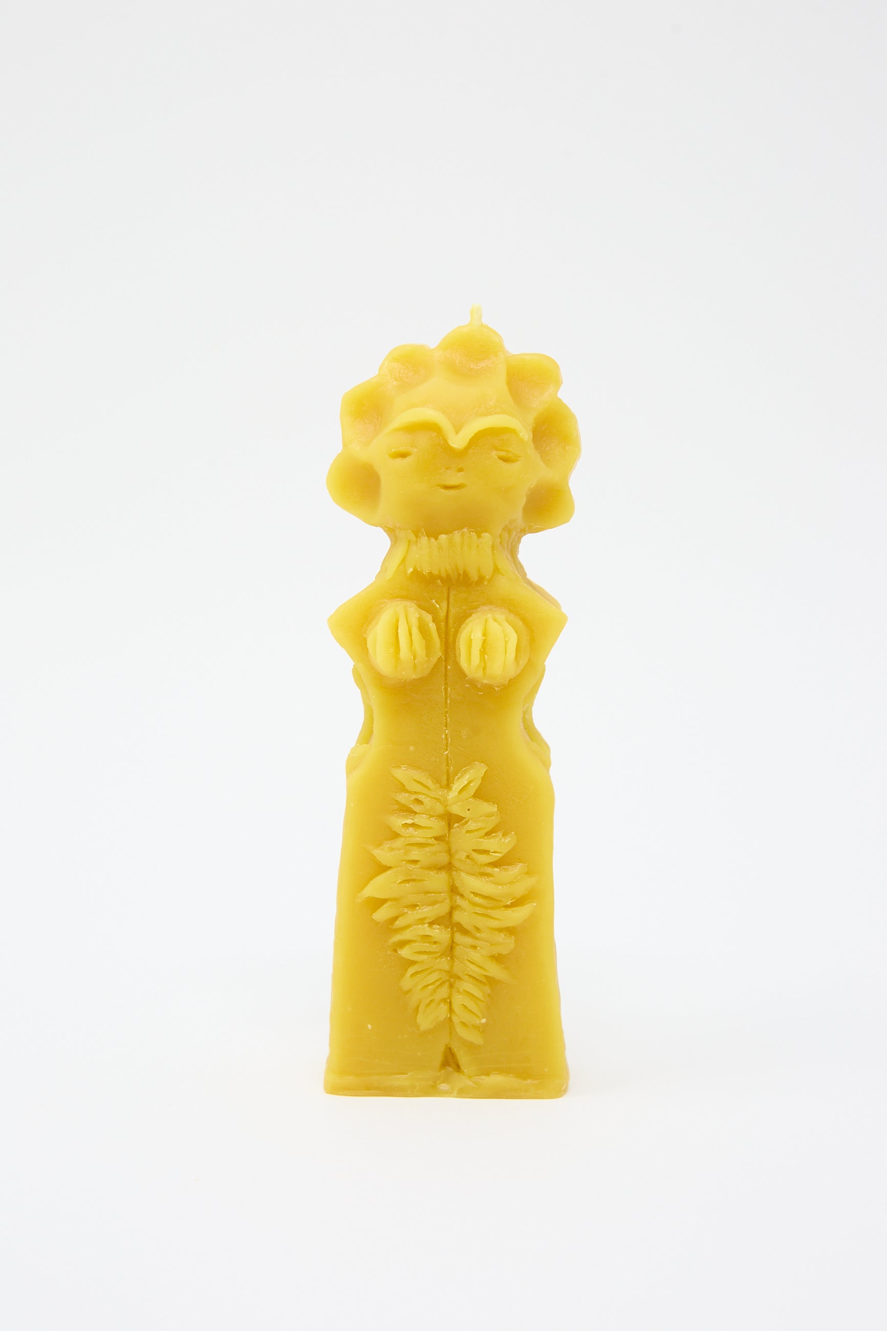 A Moon Goddess Candle by Rinn to Hitsuji, shaped like a figure with sun details and intricate patterns, hand formed on a white background.
