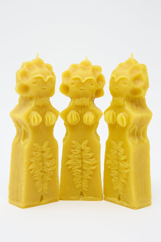 Three Moon Goddess candles from Rinn to Hitsuji, hand formed and adorned with floral and leaf patterns, standing upright against a white background.