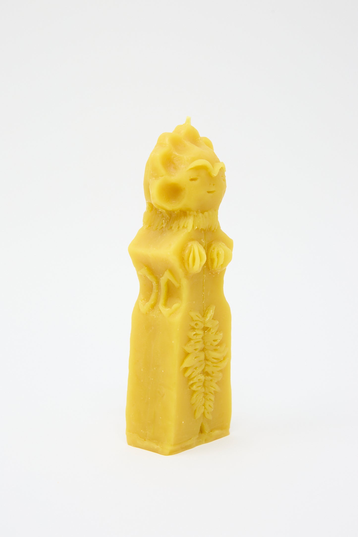 A yellow Moon Goddess Candle shaped like a cat wearing a regal robe and crown, hand formed and set against a white background by Rinn to Hitsuji.