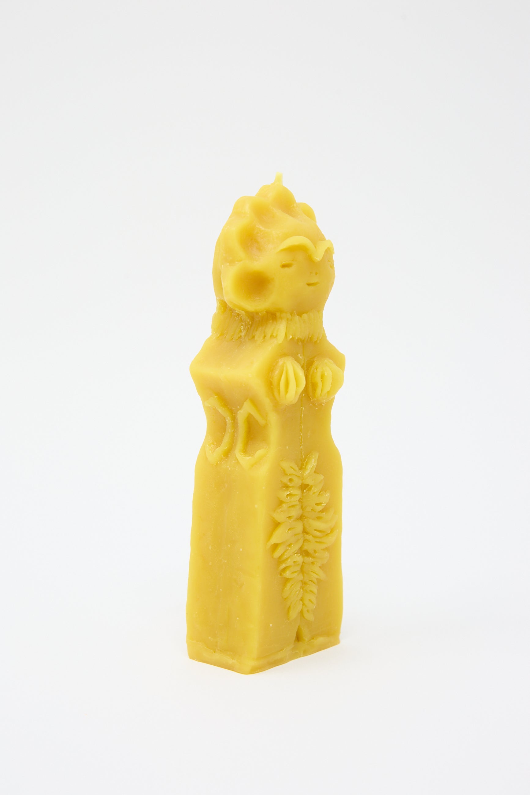 A yellow Moon Goddess Candle shaped like a cat wearing a regal robe and crown, hand formed and set against a white background by Rinn to Hitsuji.