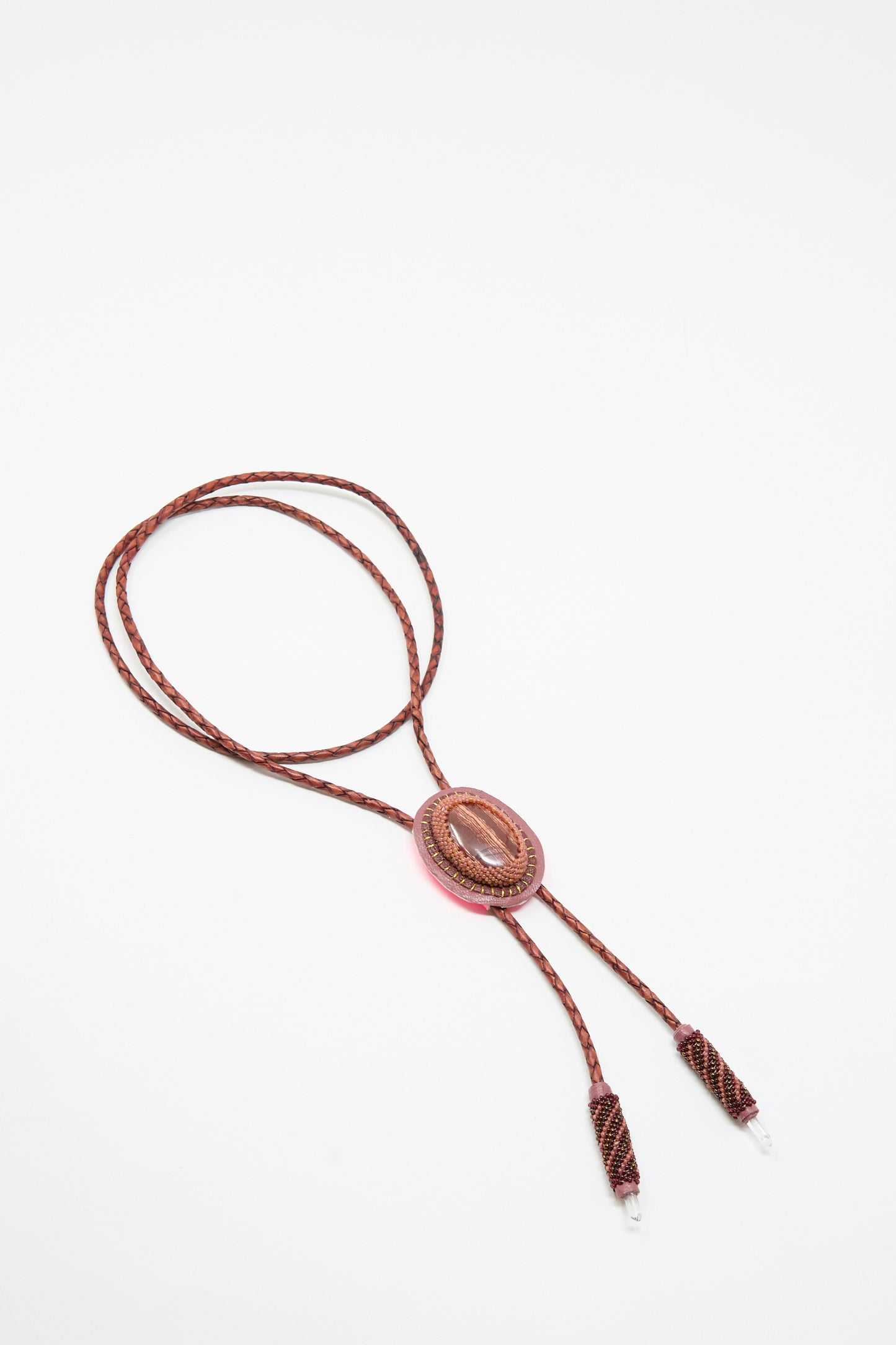 The Robin Mollicone Bolo Necklace in Snakeskin Jasper and Quartz is handmade in NYC, featuring an oval jasper centerpiece and metal tips, displayed on a white background.