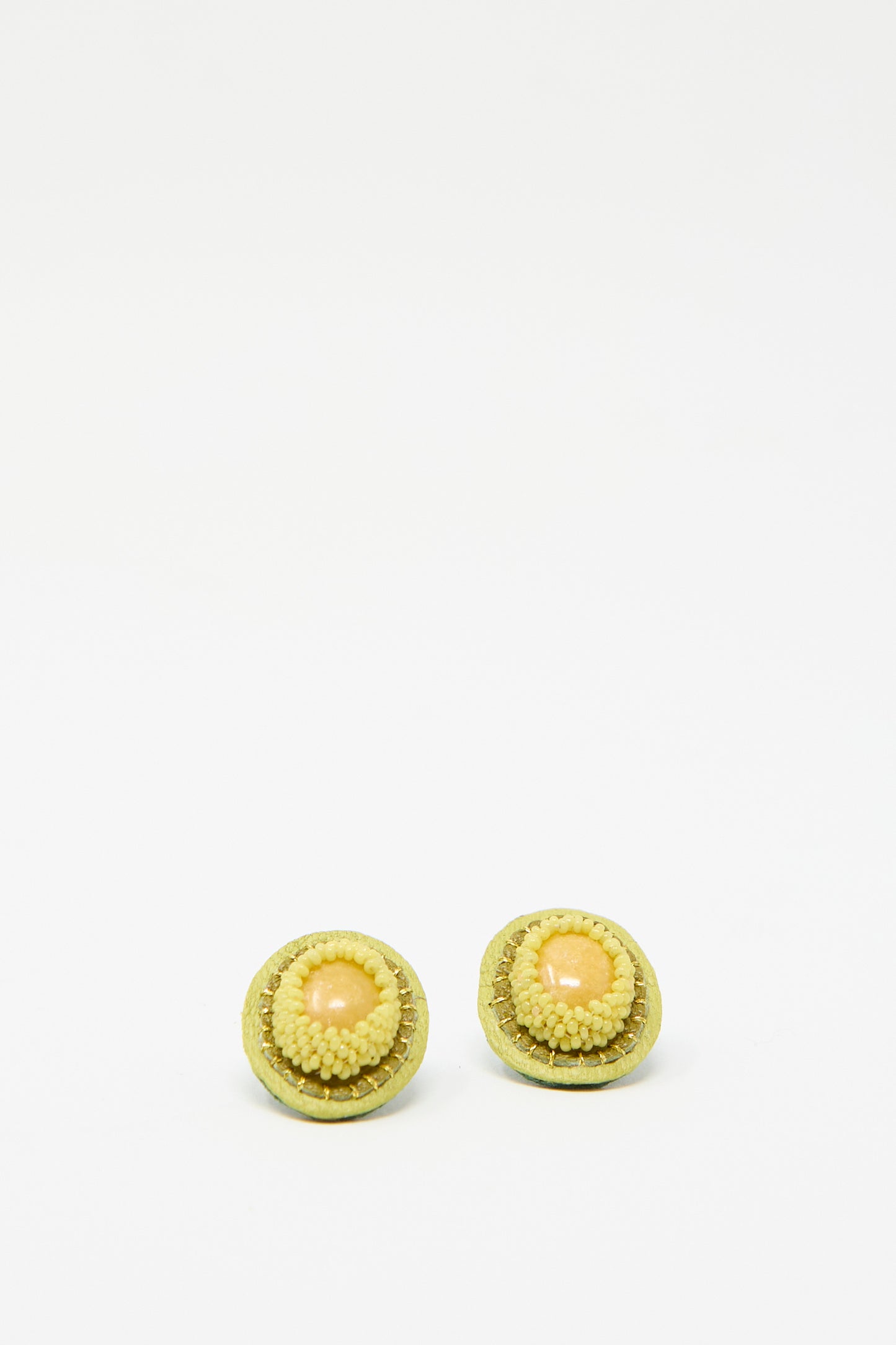 Robin Mollicone's handcrafted oval earrings in yellow jasper against a plain white background.